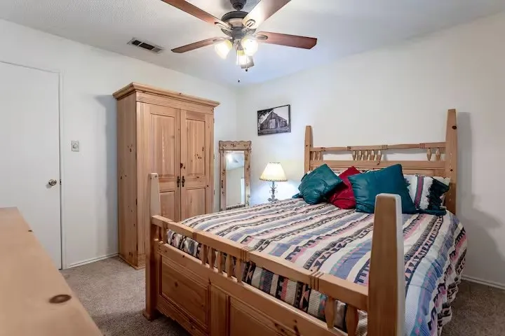 Carpeted bedroom with ceiling fan