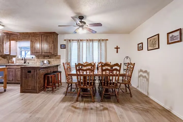 Dining space with ceiling fan and light wood-style floors