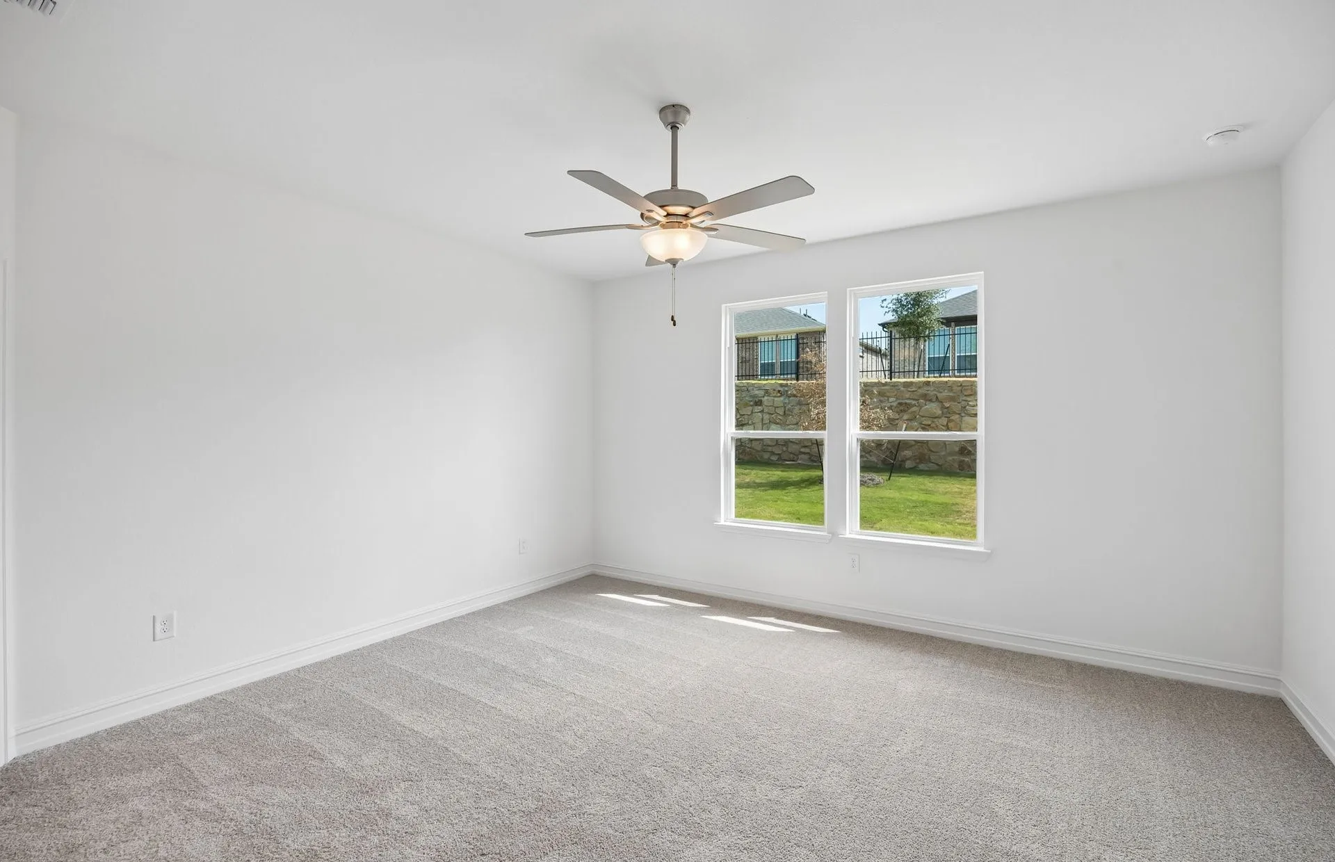 Primary bedroom with large windows