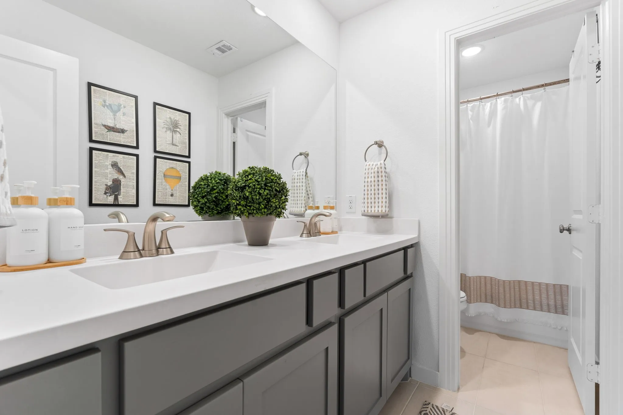 Large full bathroom upstairs with dual sinks.