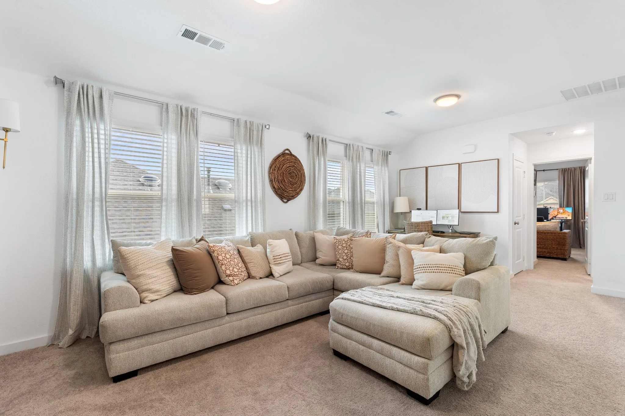 Oversized game room has space for lounging and desk.