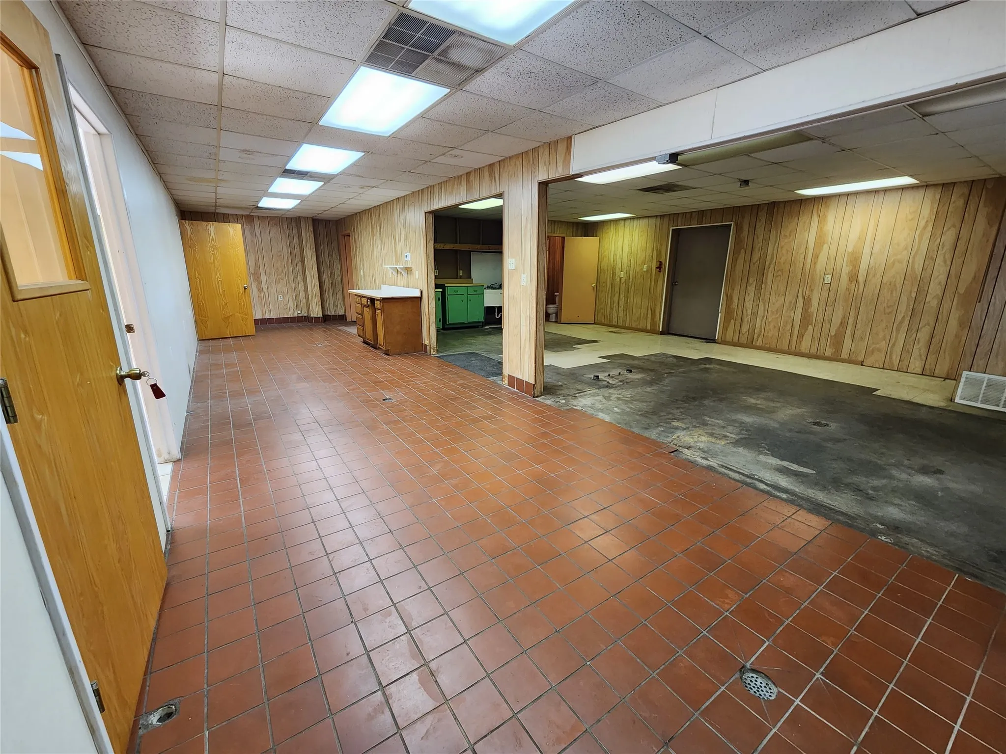 This property features wood paneling, tiled flooring, and multiple doorways