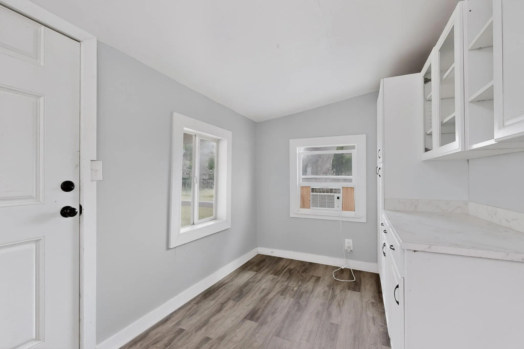 Laundry room with window unit and extra storage