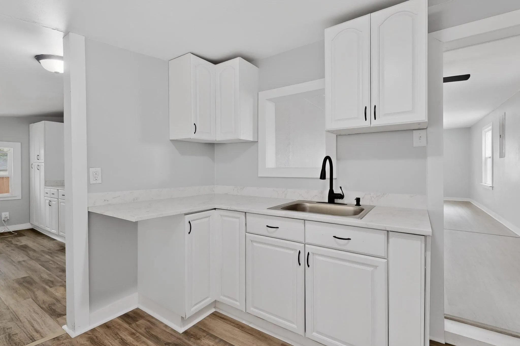 The kitchen open to the laundry room in the back