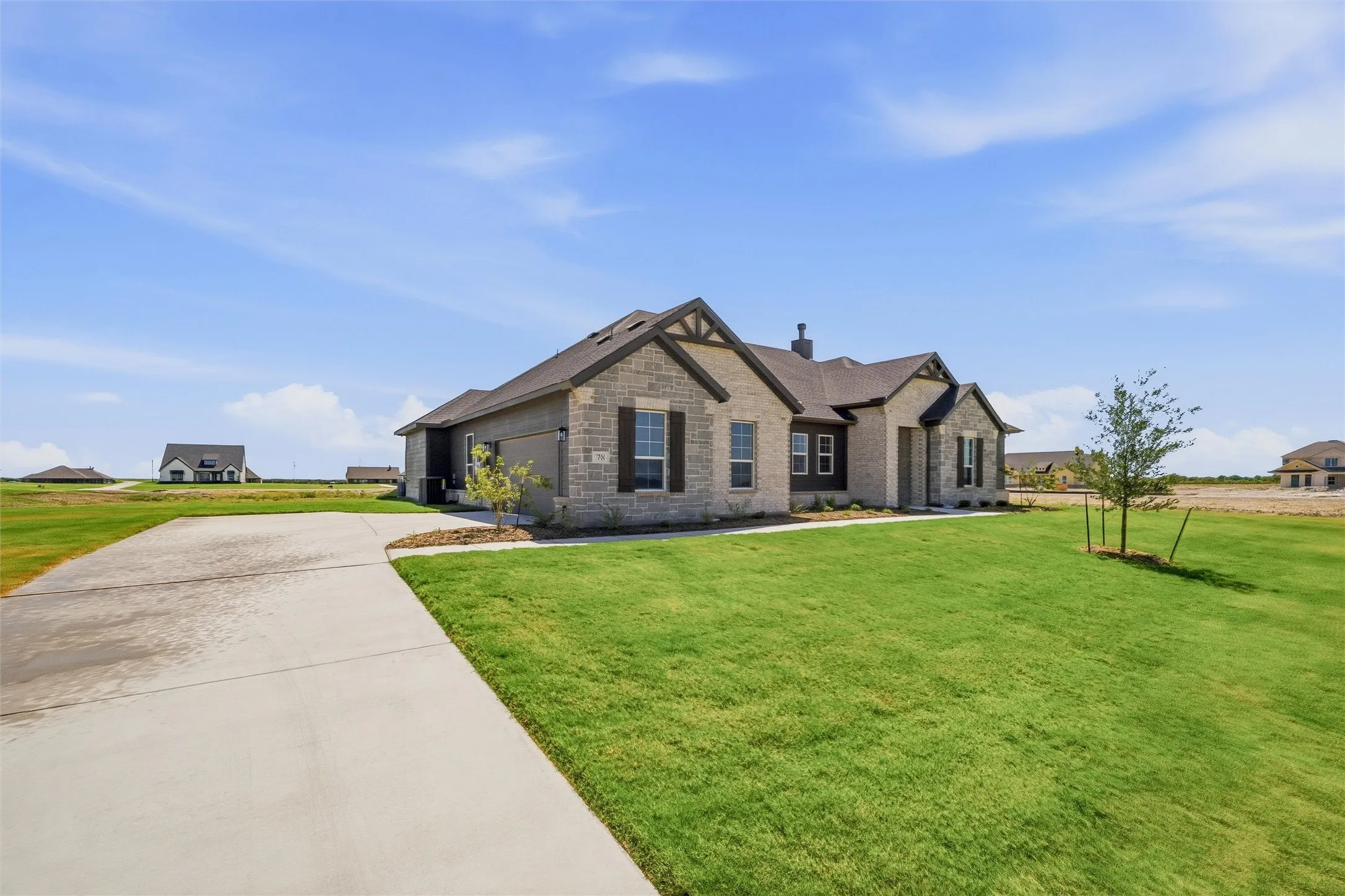 Elegant stone and brick exterior with a gabled roofline and dark architectural accents