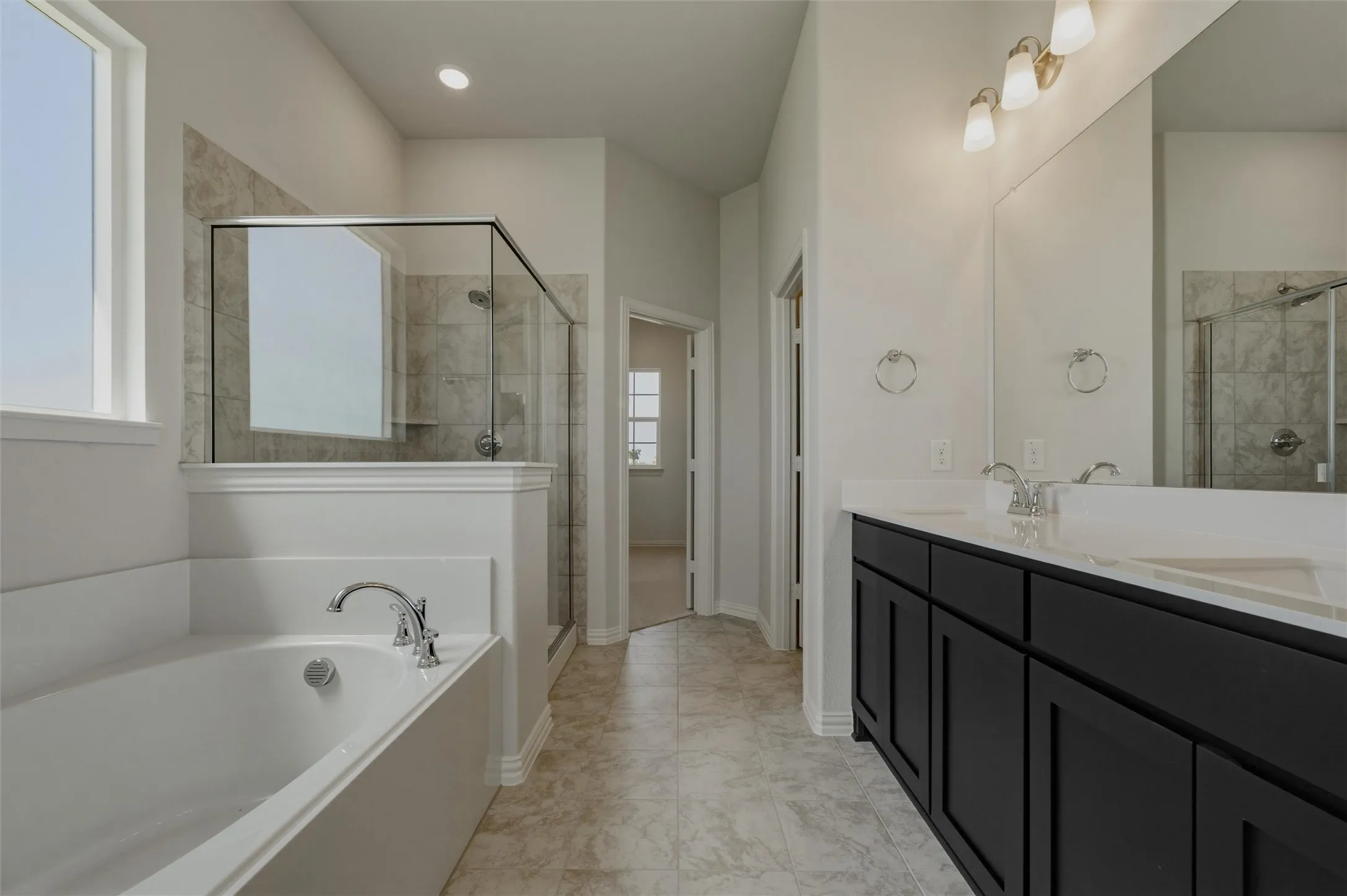 Dual vanity with black cabinetry and white countertops