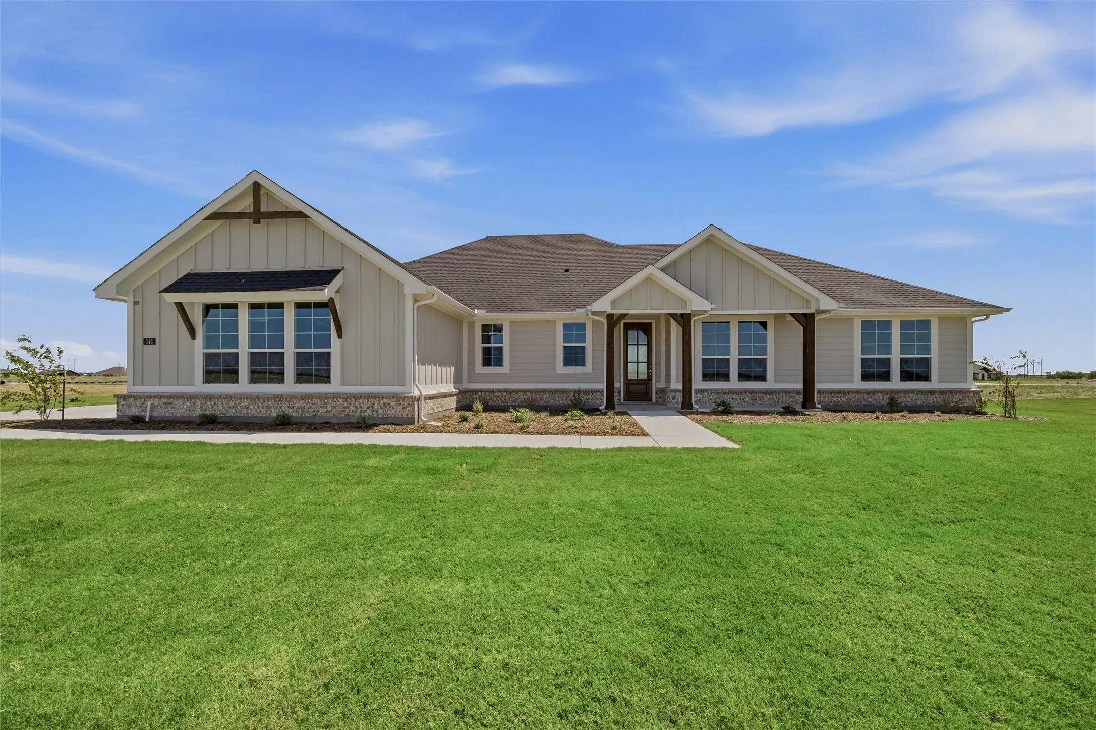 Craftsman-style exterior with a stone veneer foundation and board and batten siding