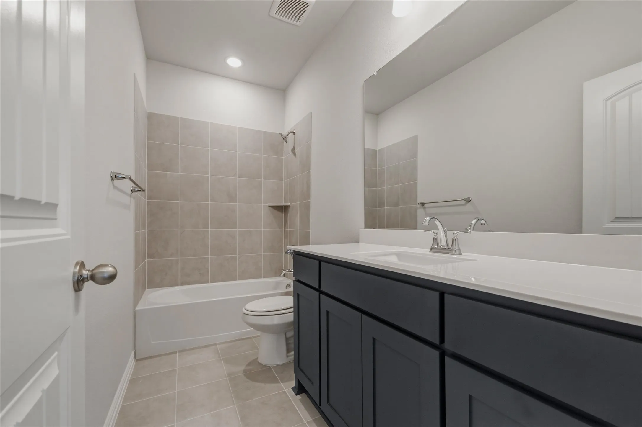 Contemporary vanity with a white countertop and integrated sink