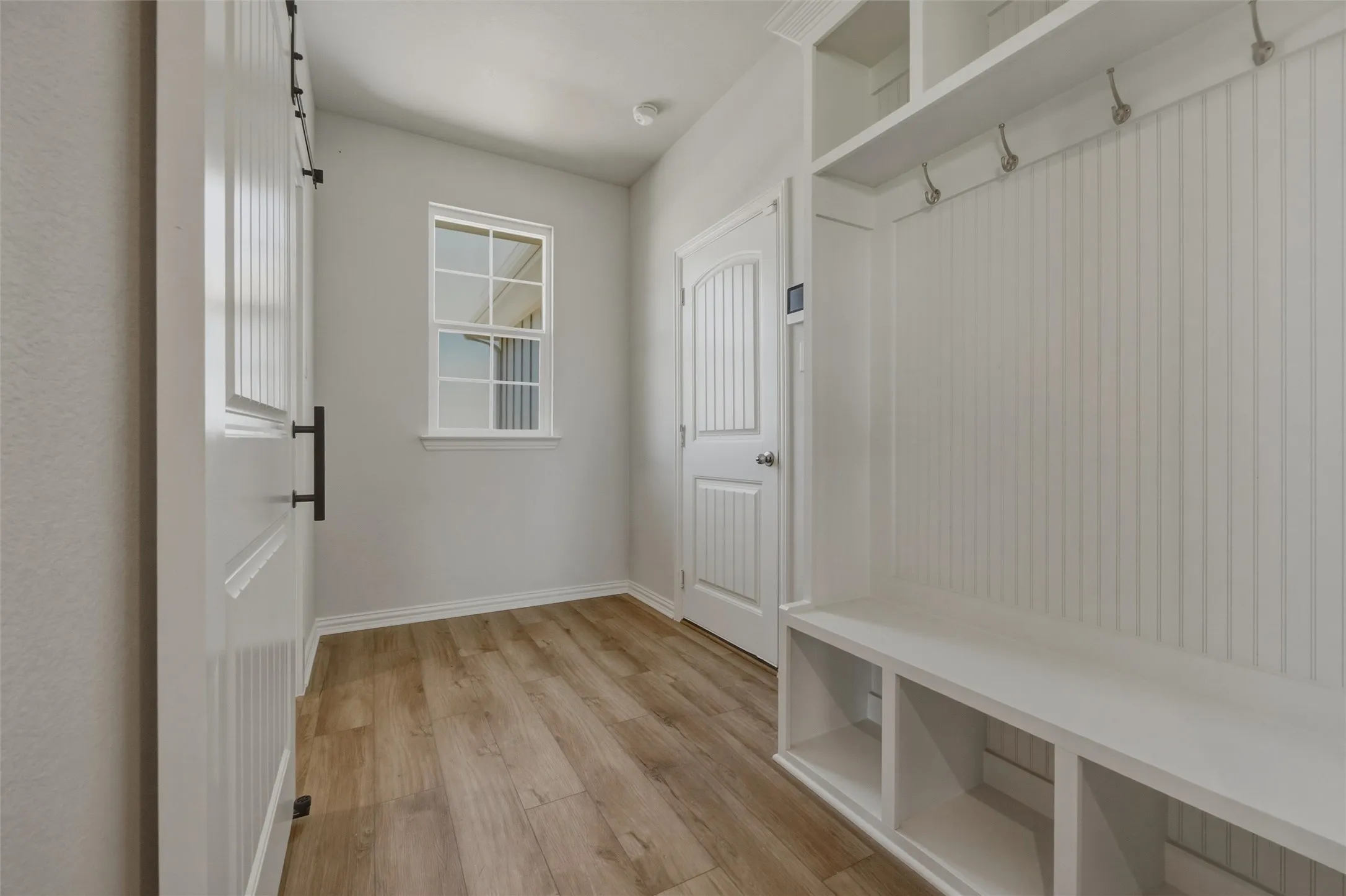 Built-in hall tree with storage compartments and coat hooks