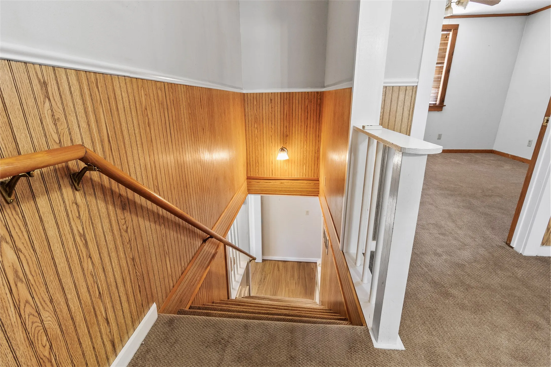 Stairway with wood walls and carpet floors