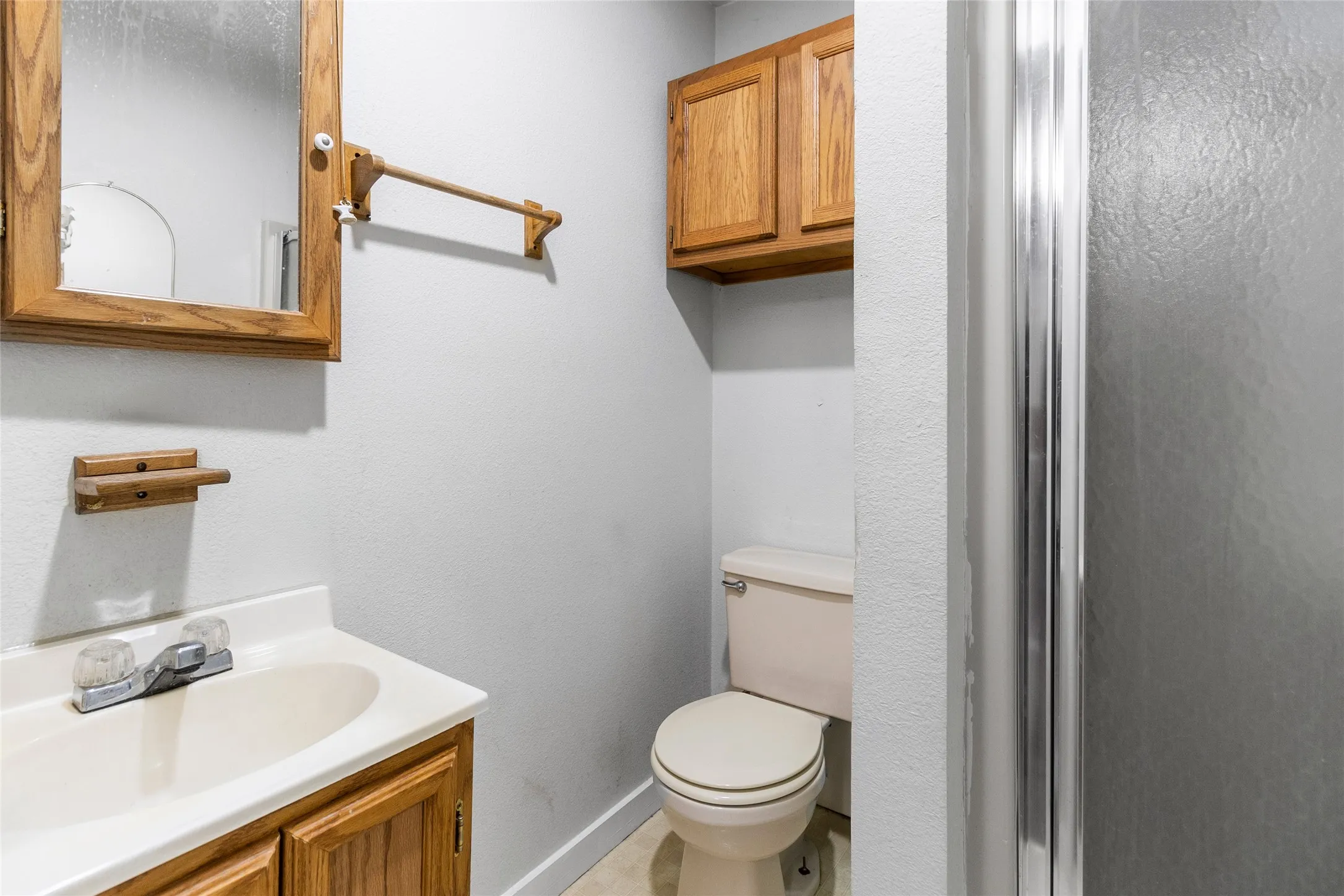Bathroom with tile floors, vanity, and toilet