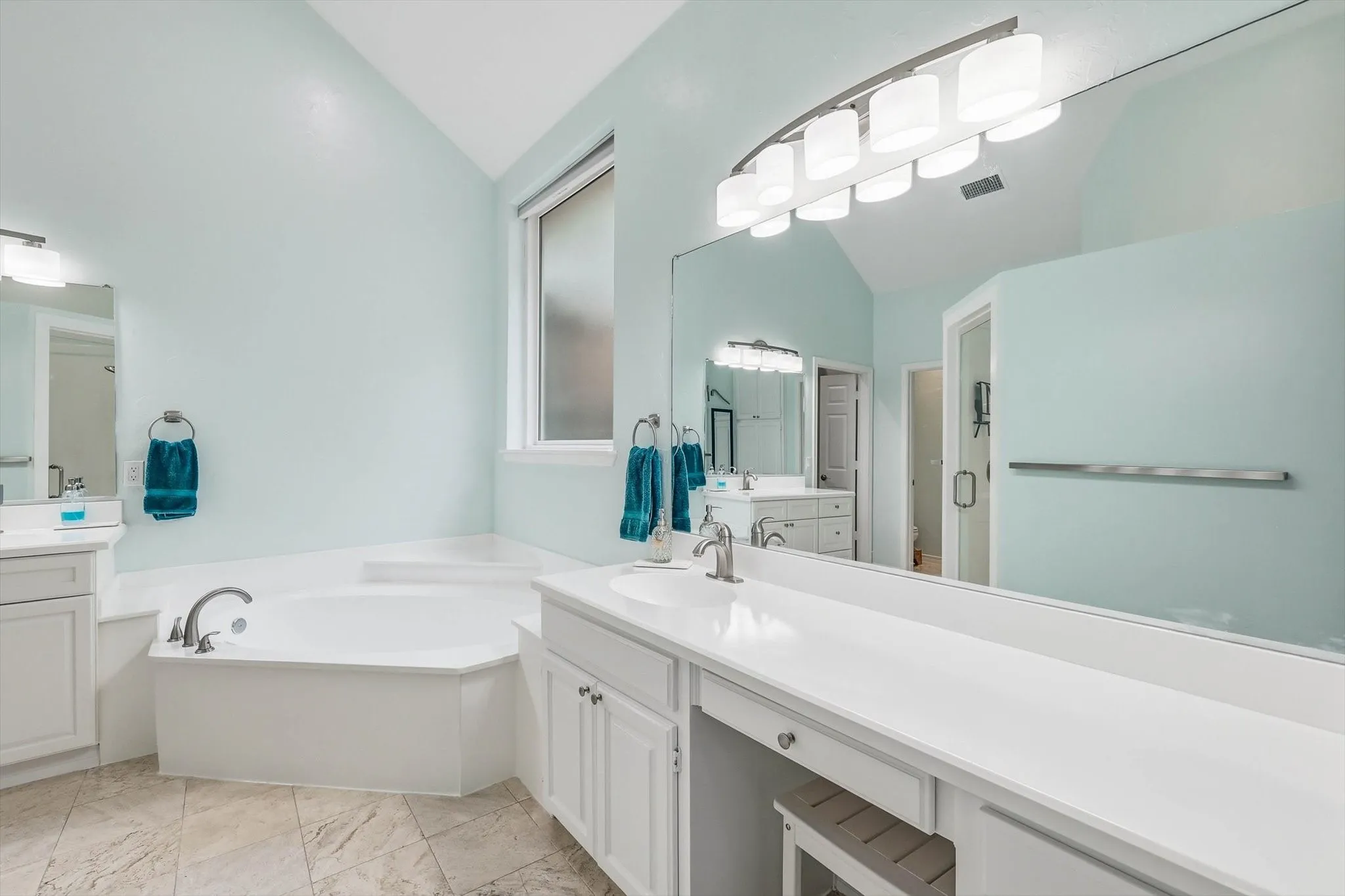 This large bathroom has double vanities with lots of cabinet space.