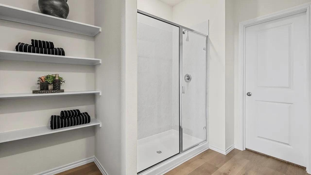 Bathroom featuring a glass-enclosed shower with a chrome showerhead and a white shower pan