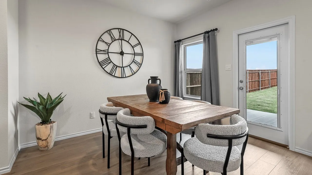 This dining area features light-colored walls and wood-look flooring