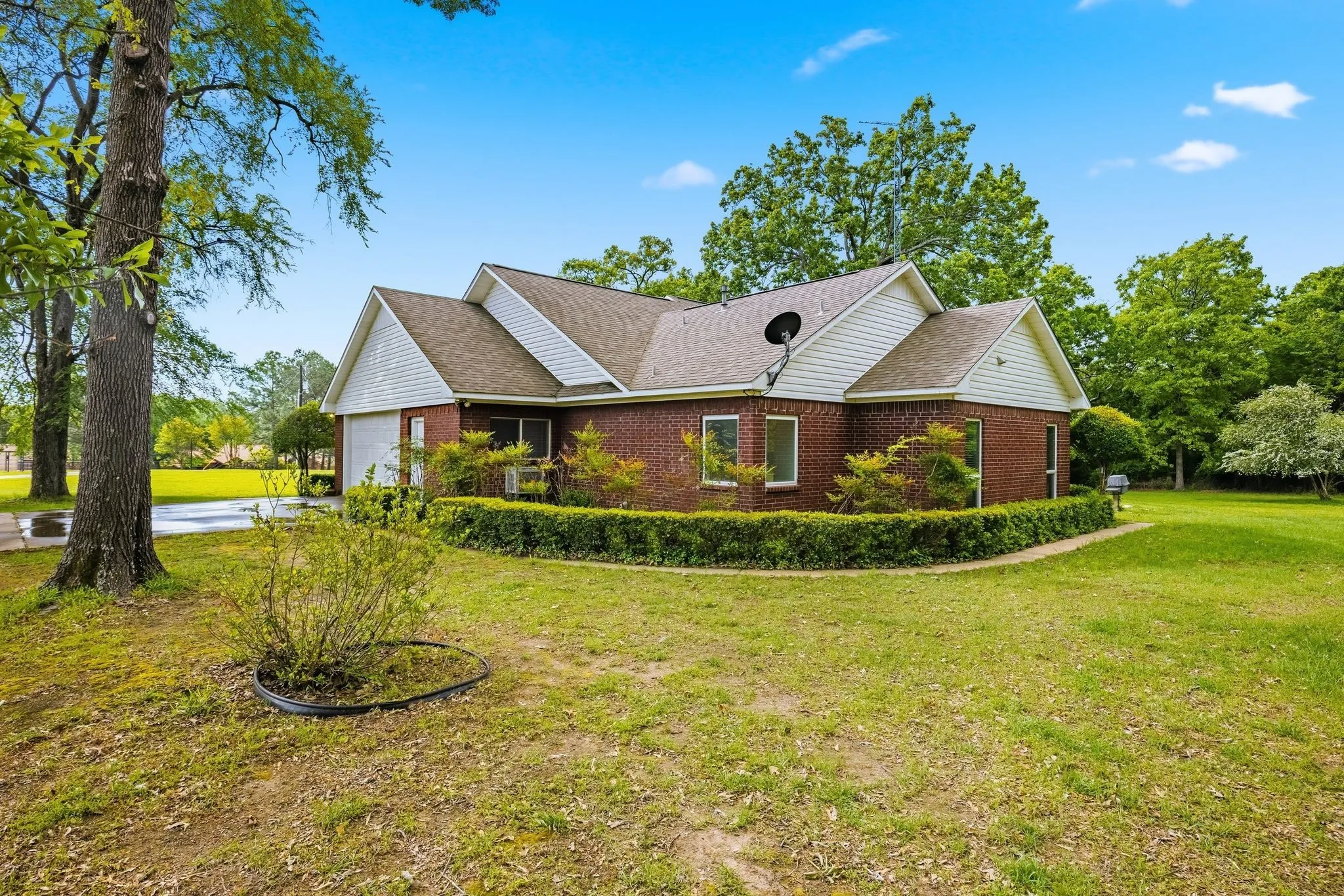 This property features a brick exterior with white siding accents and a pitched roof