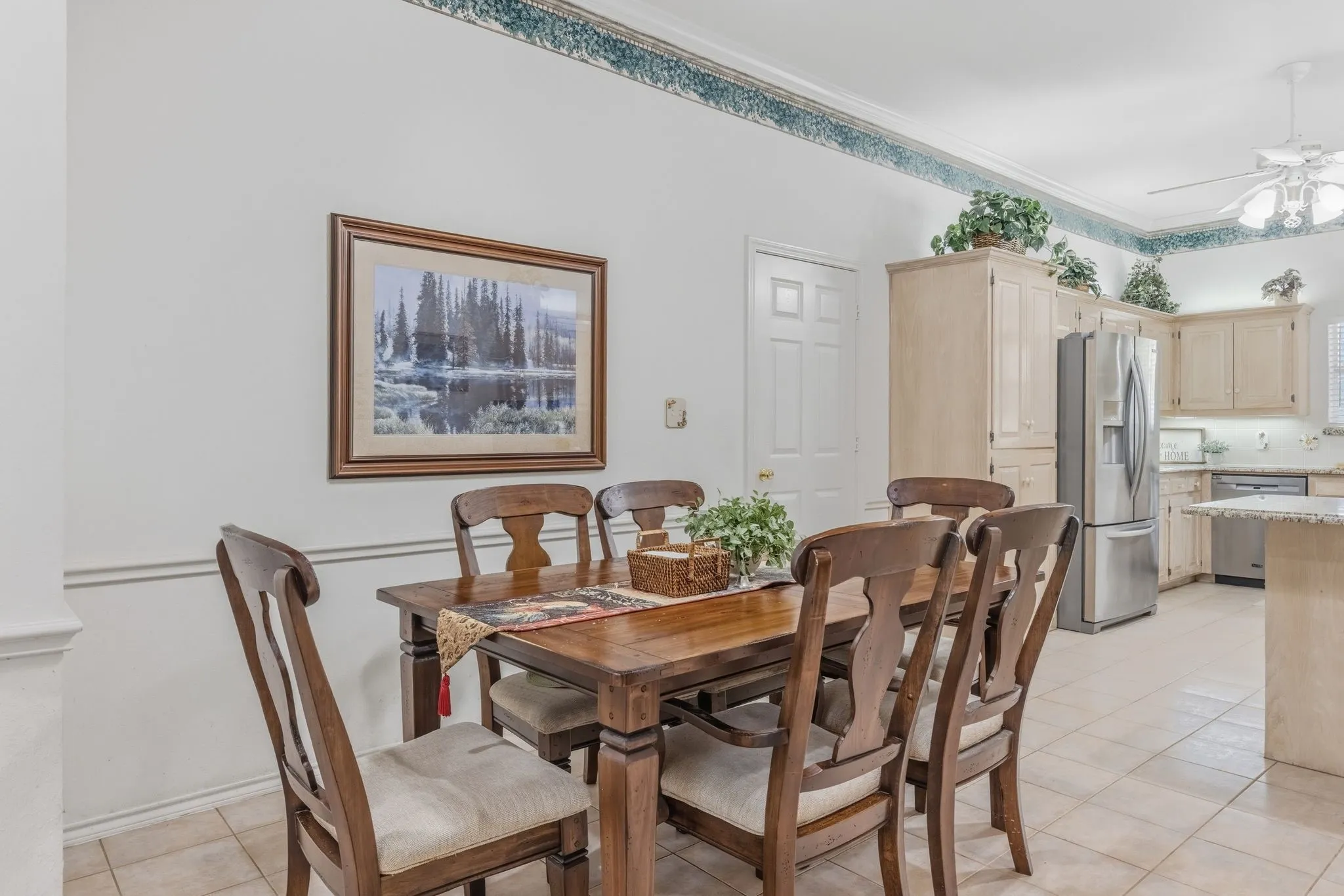 This dining area features tile flooring and crown molding
