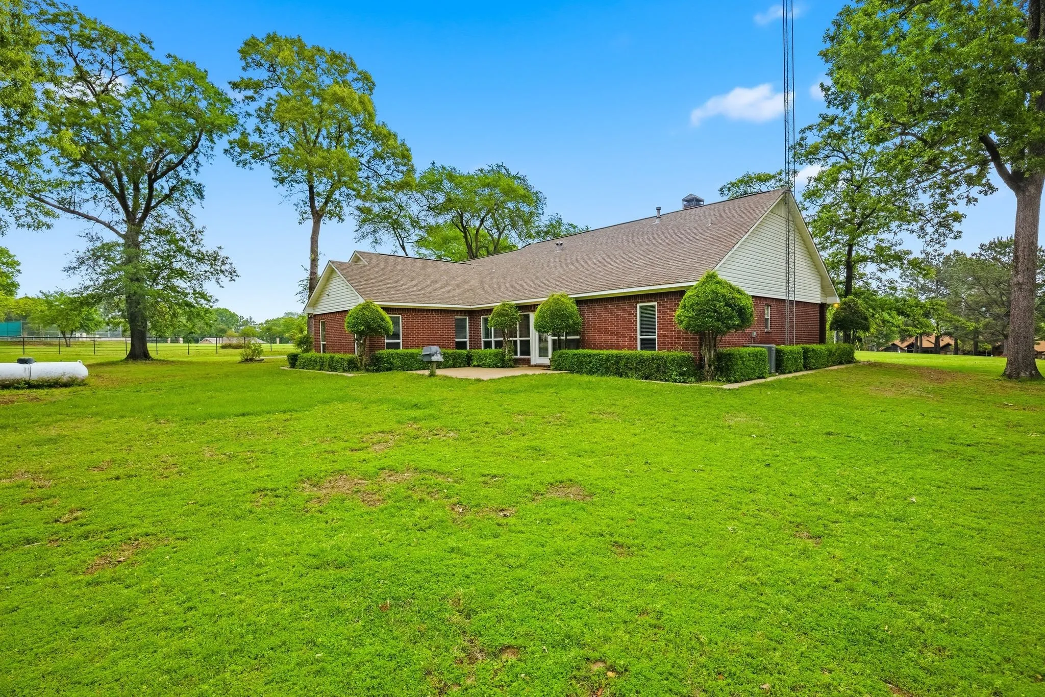 The property features a brick exterior with a gabled roof and a well-maintained lawn