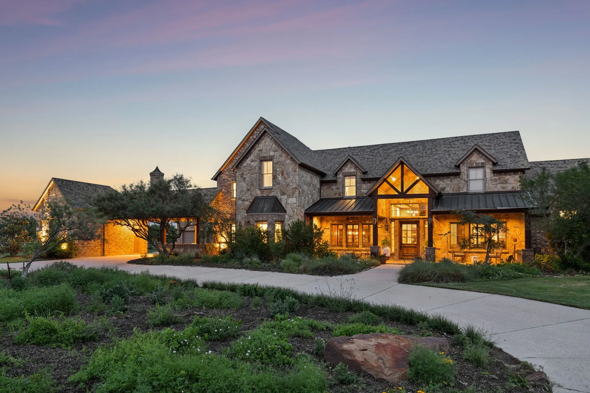 The property features an extensive stone exterior, a gabled roof, and multiple dormer windows