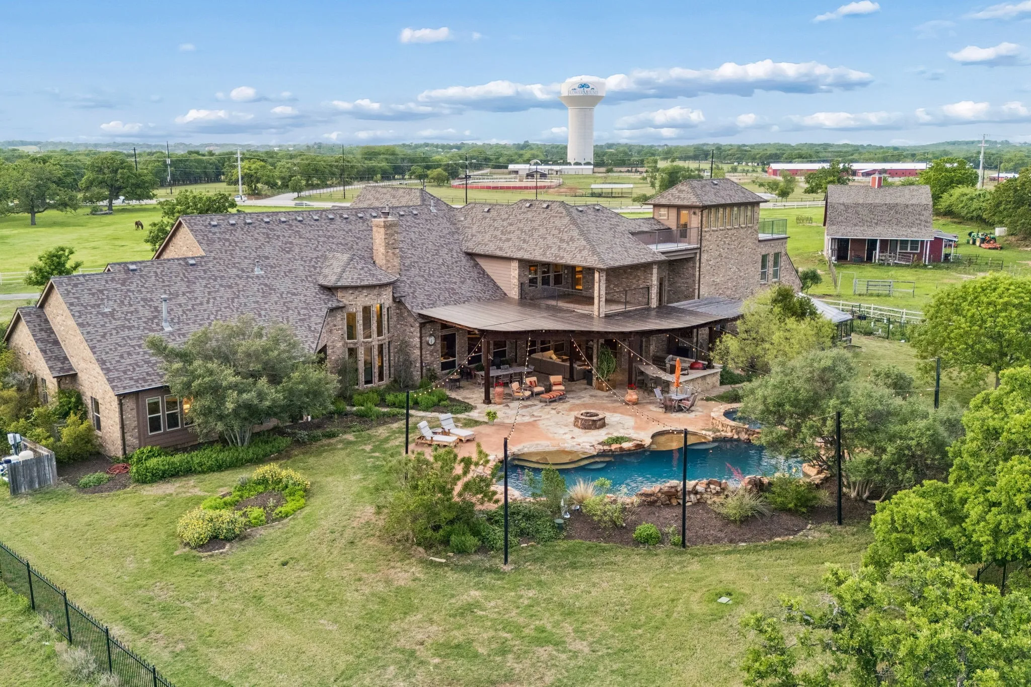 The property features a large exterior with brickwork, a substantial roof, and an expansive yard