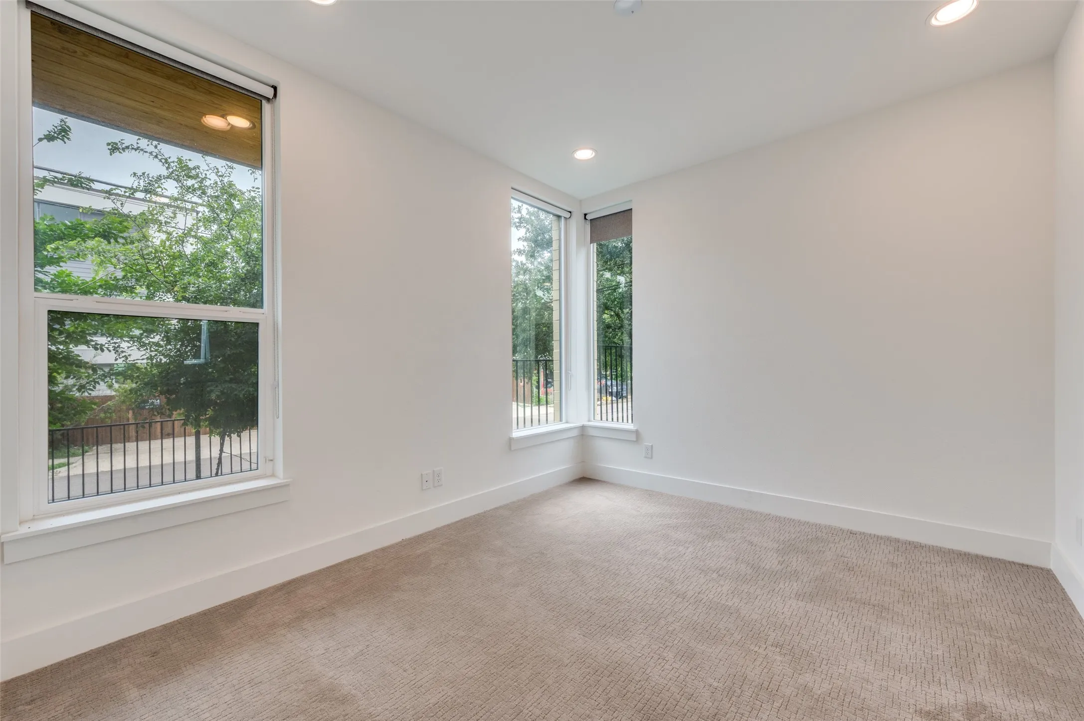 This room features light-colored walls and carpeting, with recessed lighting
