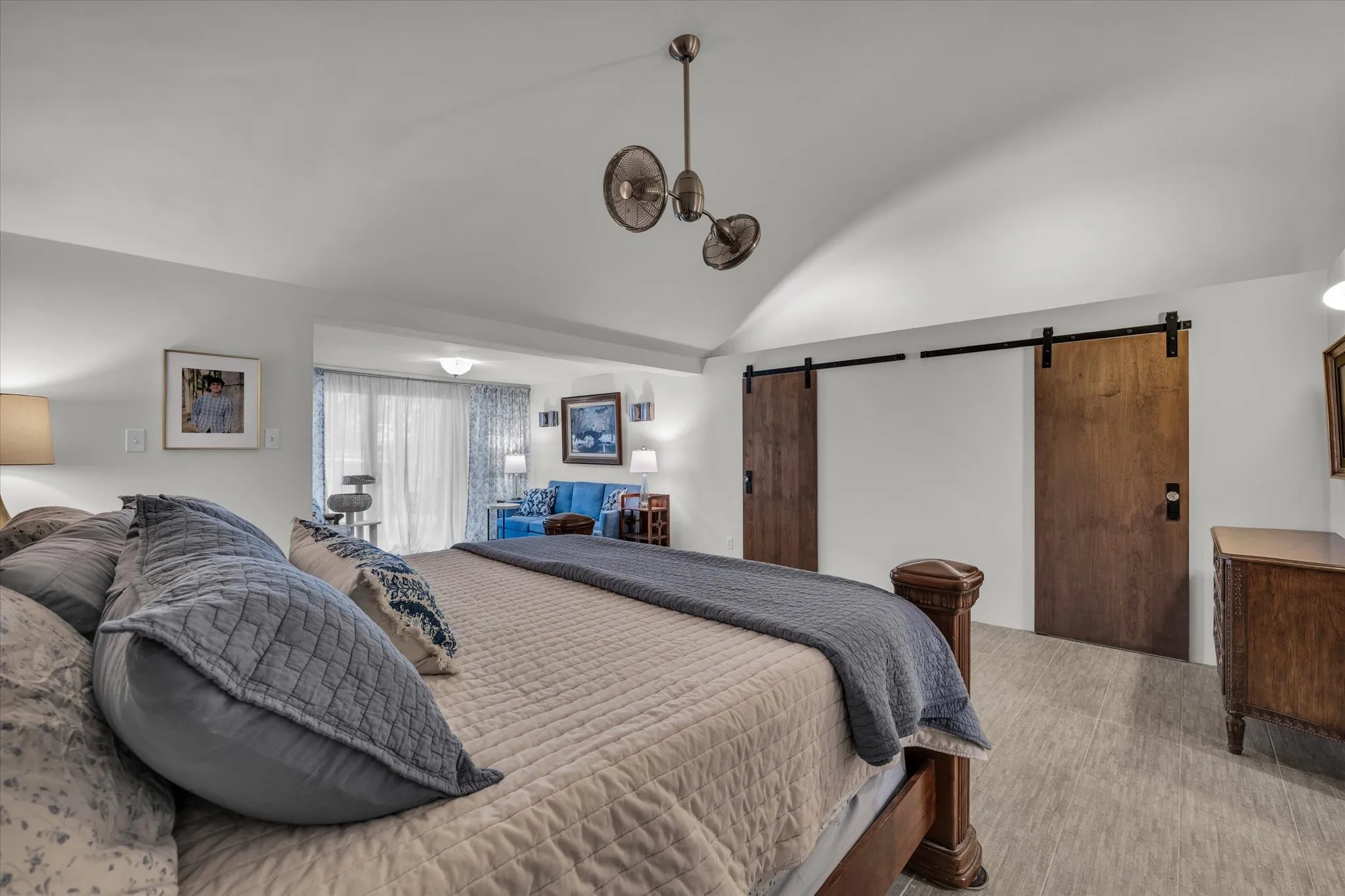 Primary bedroom featuring barn doors for the walk-in closet