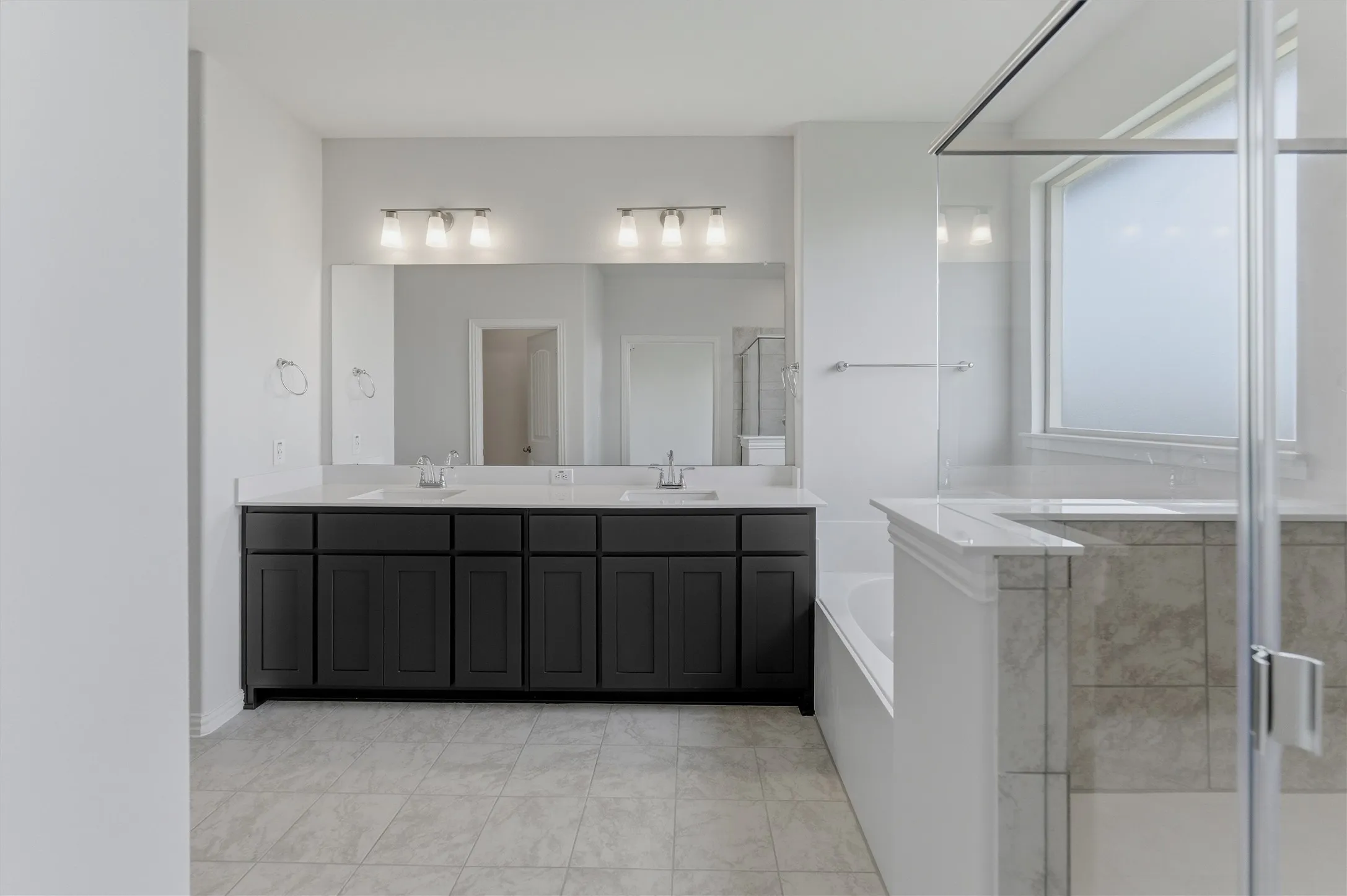 Double vanity with dark wood cabinetry, white countertops, and dual undermount sinks