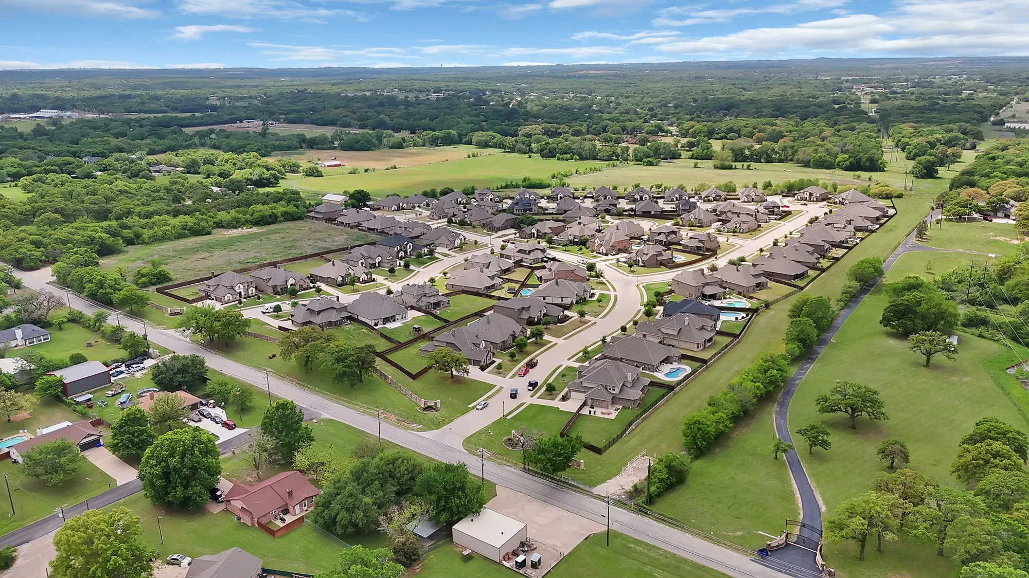 Aerial view showcasing a residential community with a variety of homes, each featuring a private yard