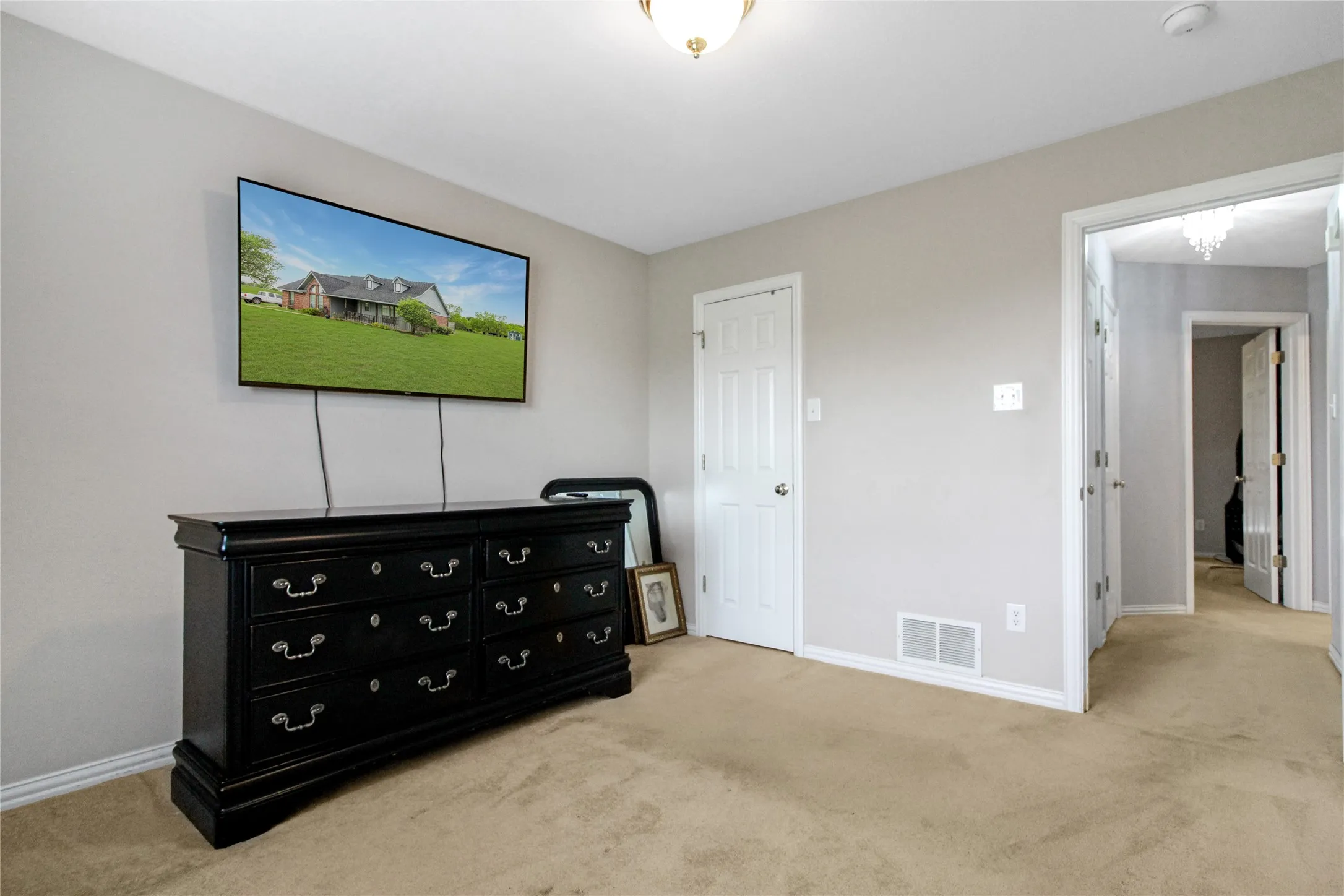 Carpeted interior space with light gray wall paint