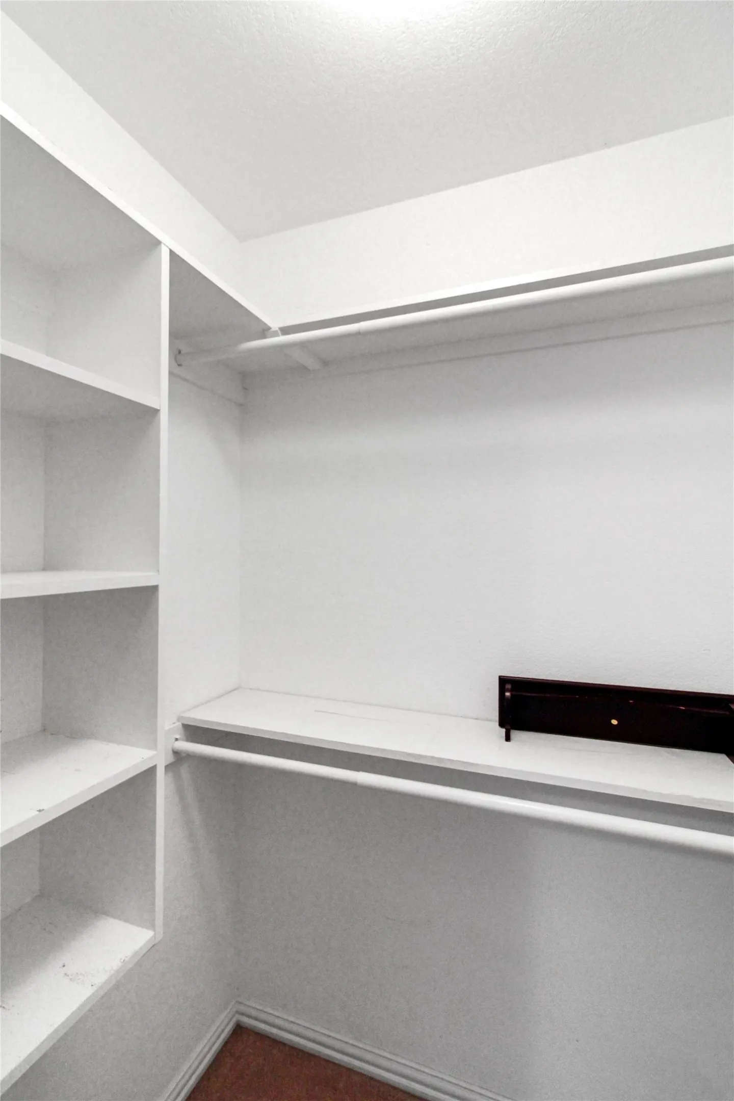 Custom closet system featuring multiple shelves and hanging rods