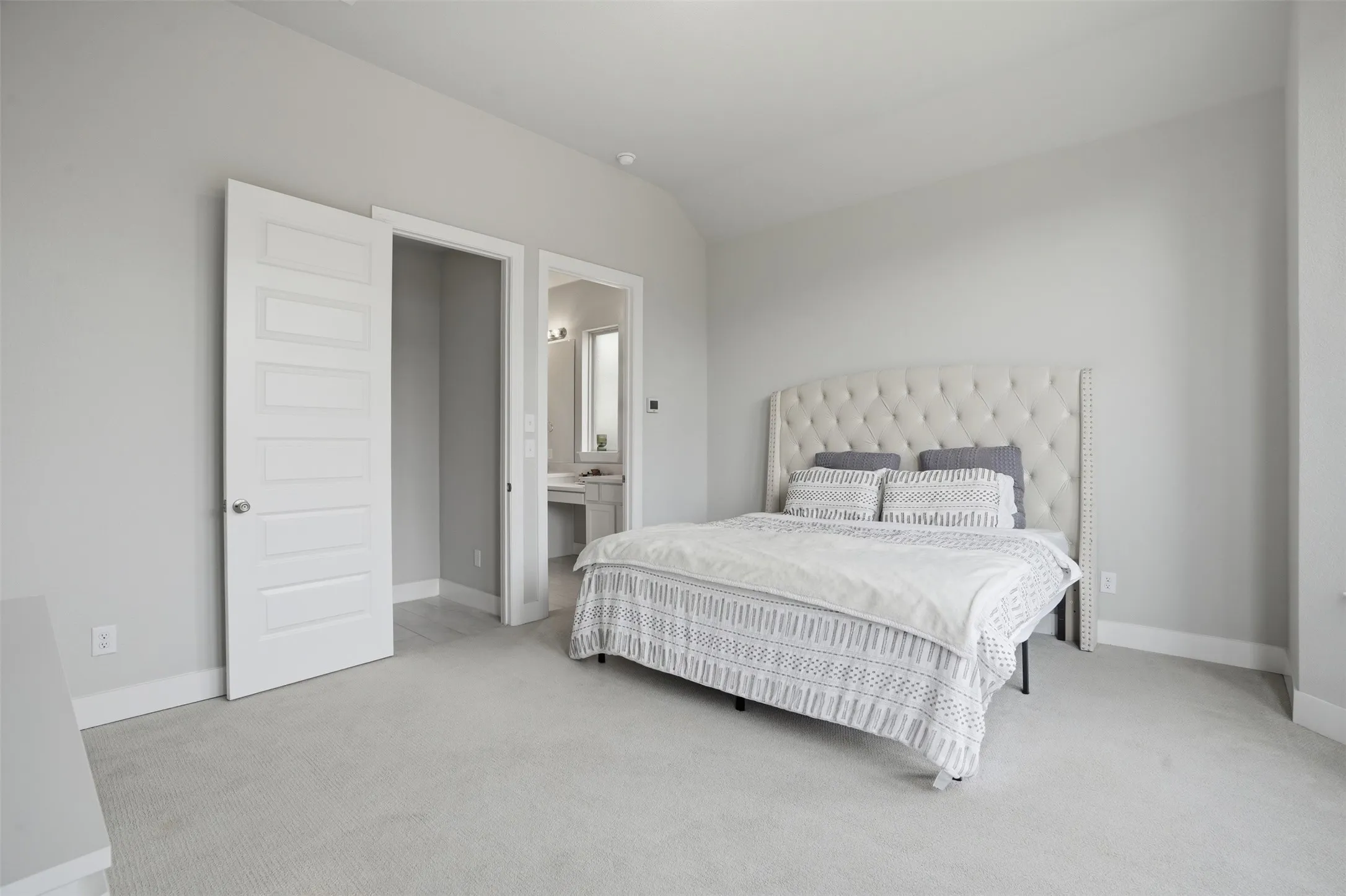 Bedroom featuring light gray walls, white trim, and light gray carpet