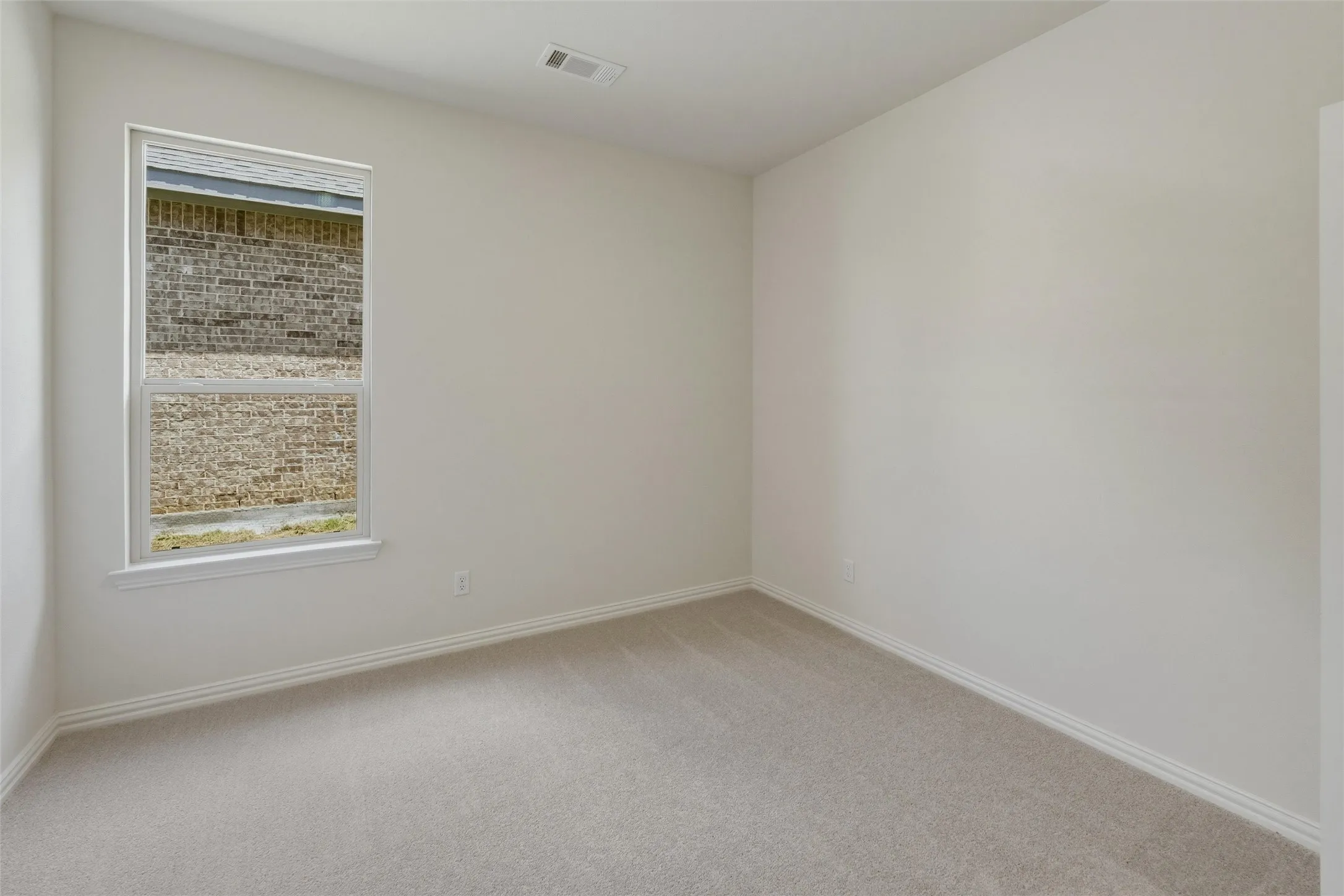 Neutral-toned carpeting complements light wall finishes