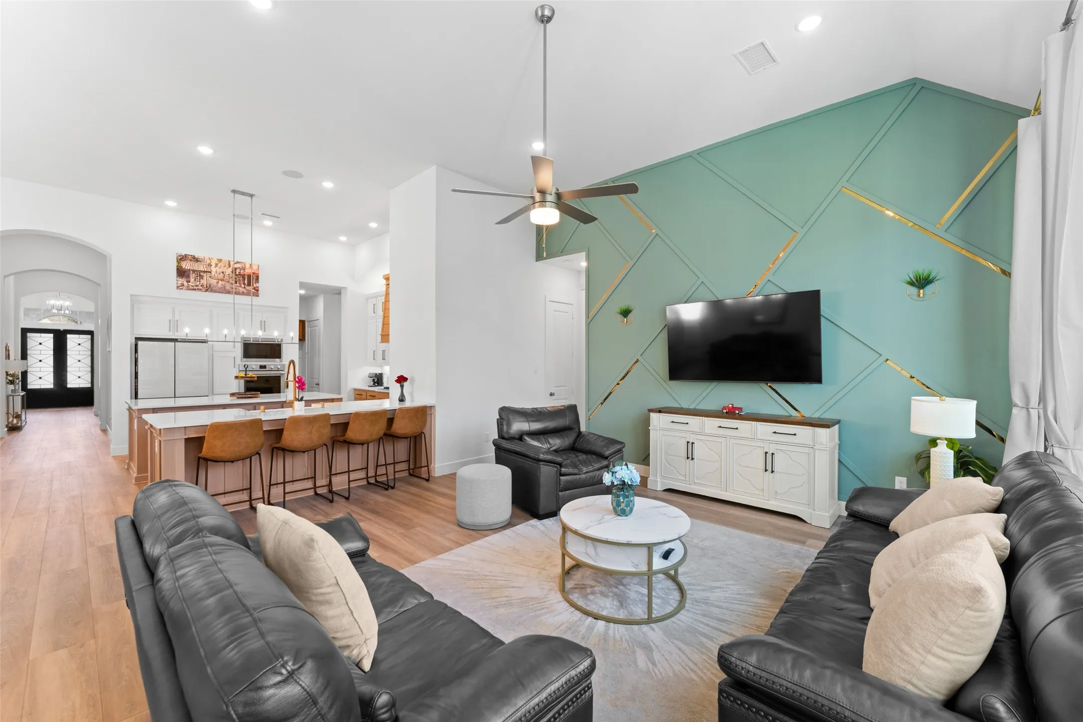 The property features an open-concept living area with a vaulted ceiling and light wood flooring