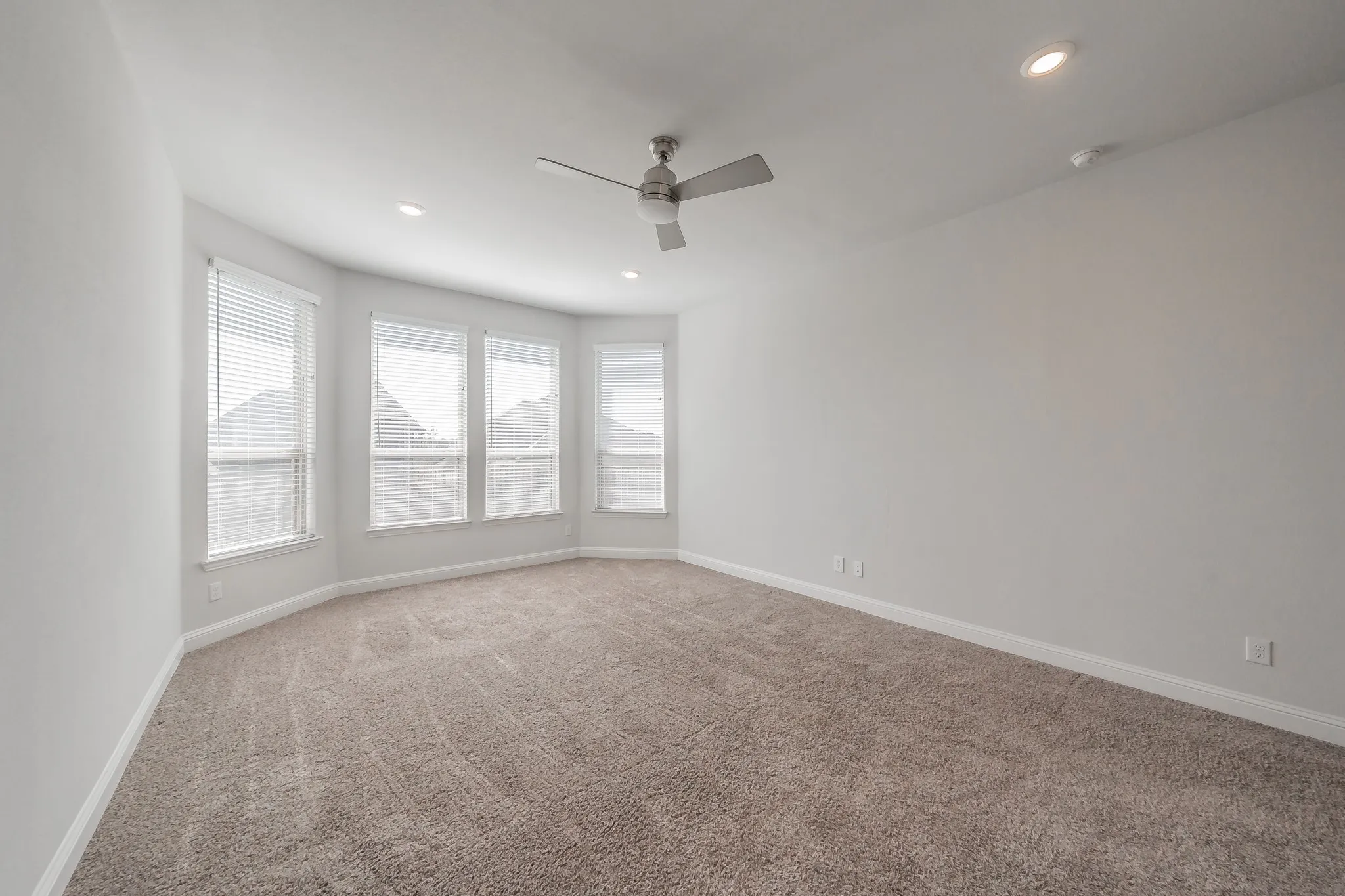 Carpeted spare room with recessed lighting and a ceiling fan