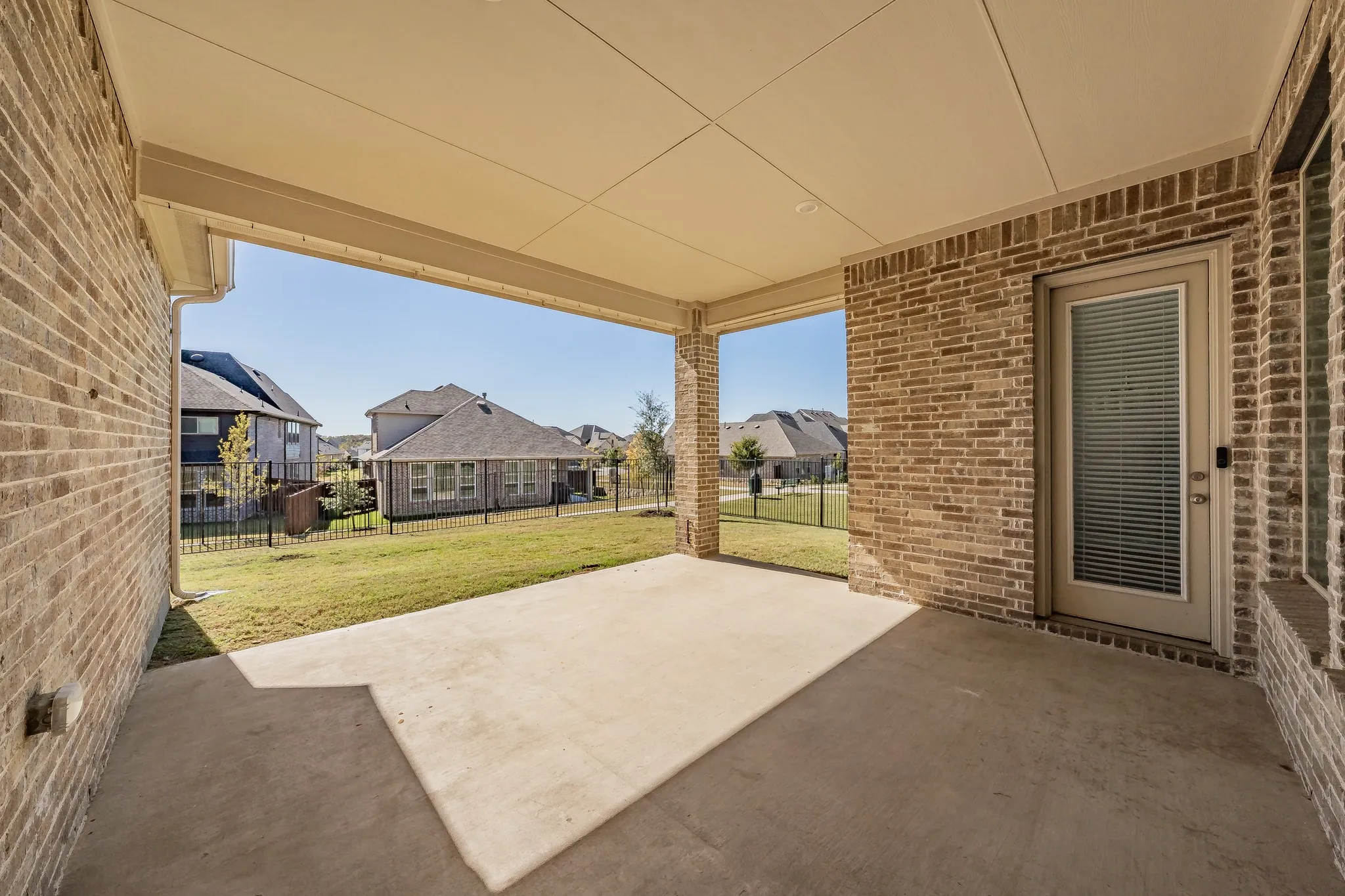 Fenced backyard with a patio area and a residential view