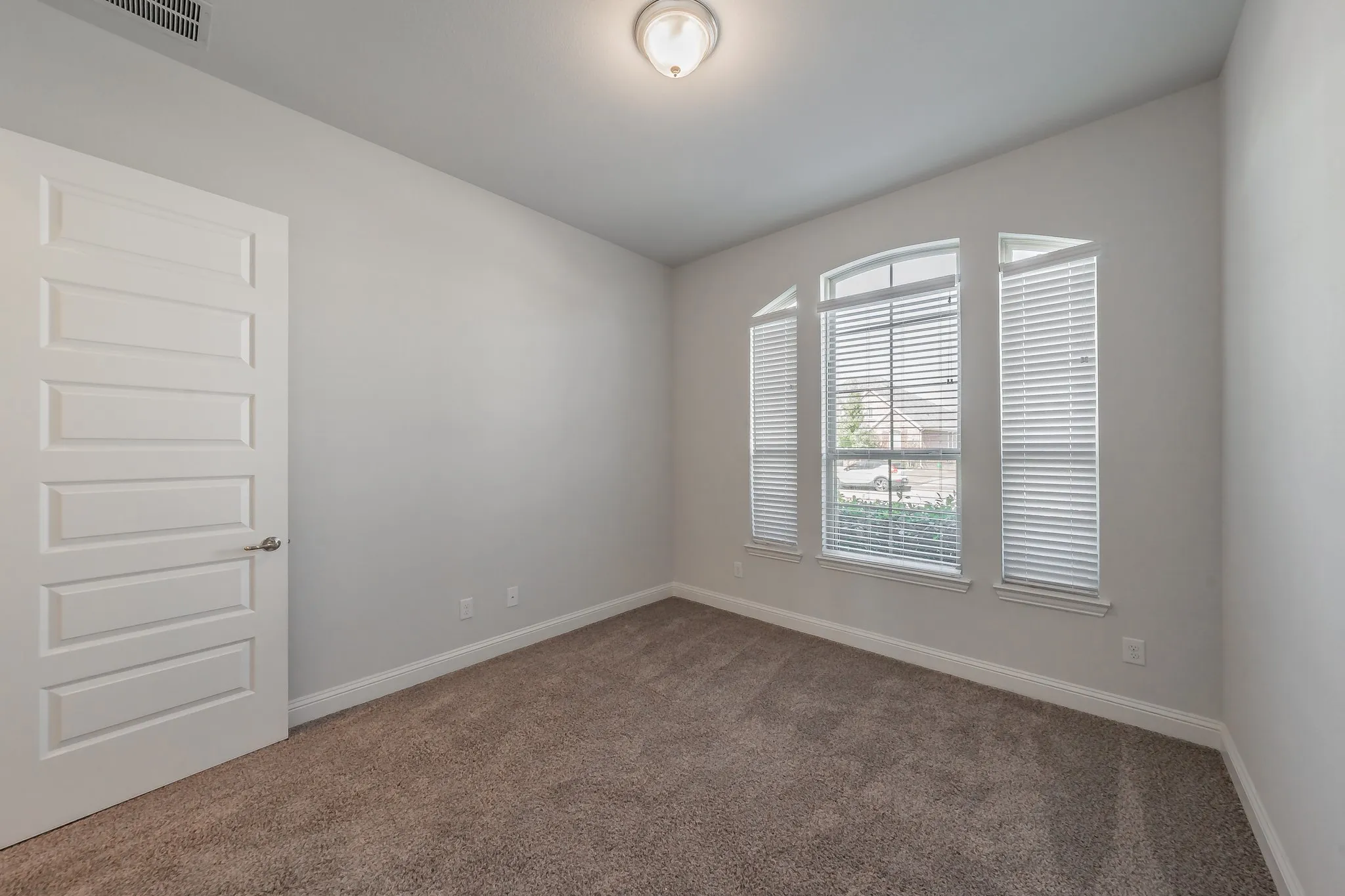 Carpeted empty room featuring baseboards