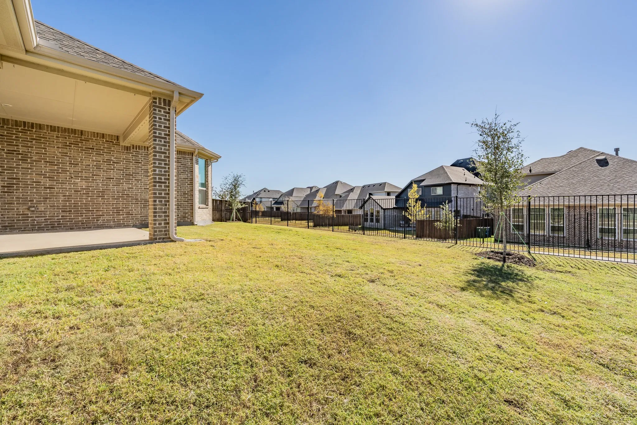 Fenced backyard featuring a patio and a residential view