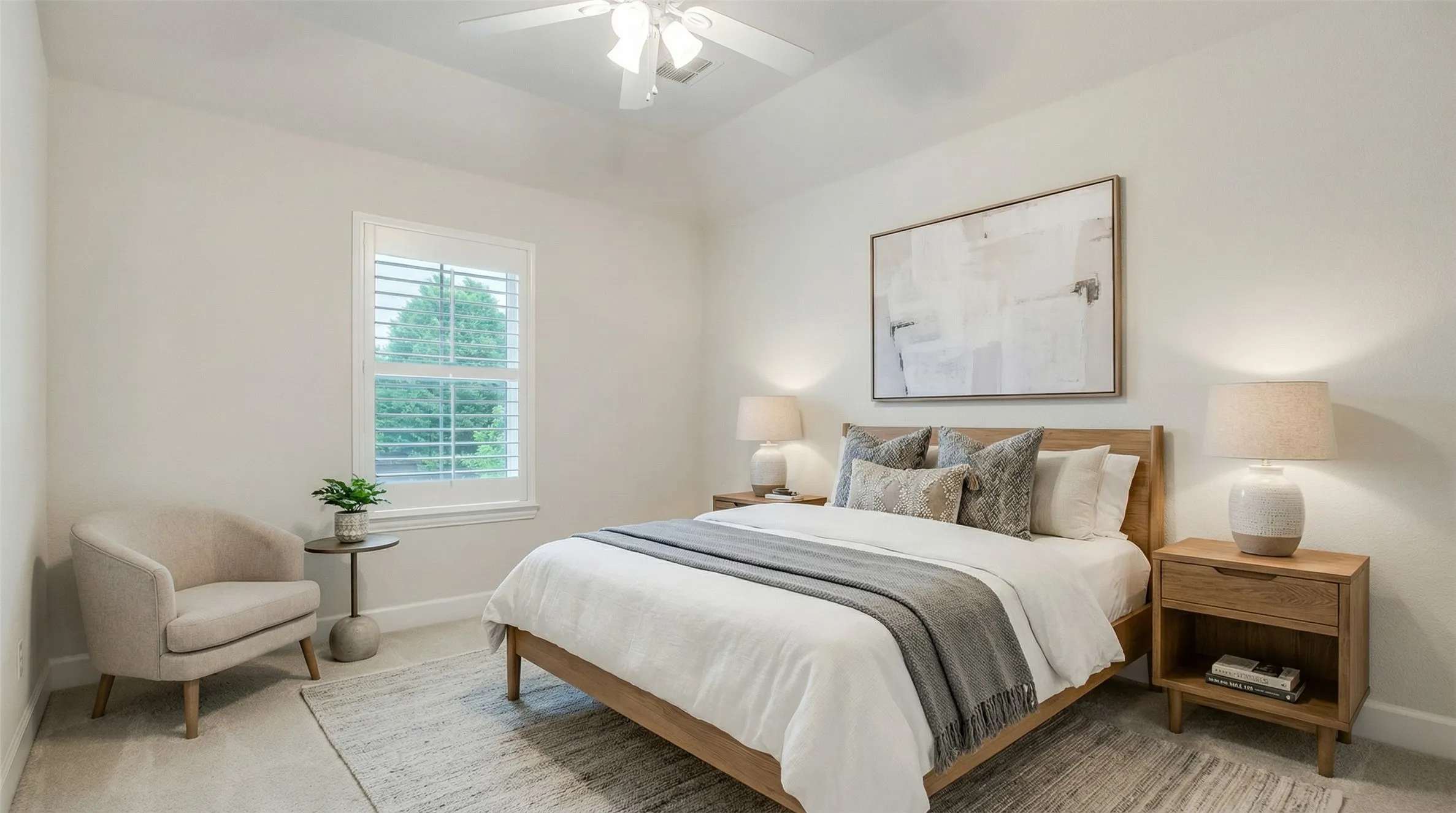 The bedroom features a window with white louvered shutters, light-colored walls, and a ceiling fan
