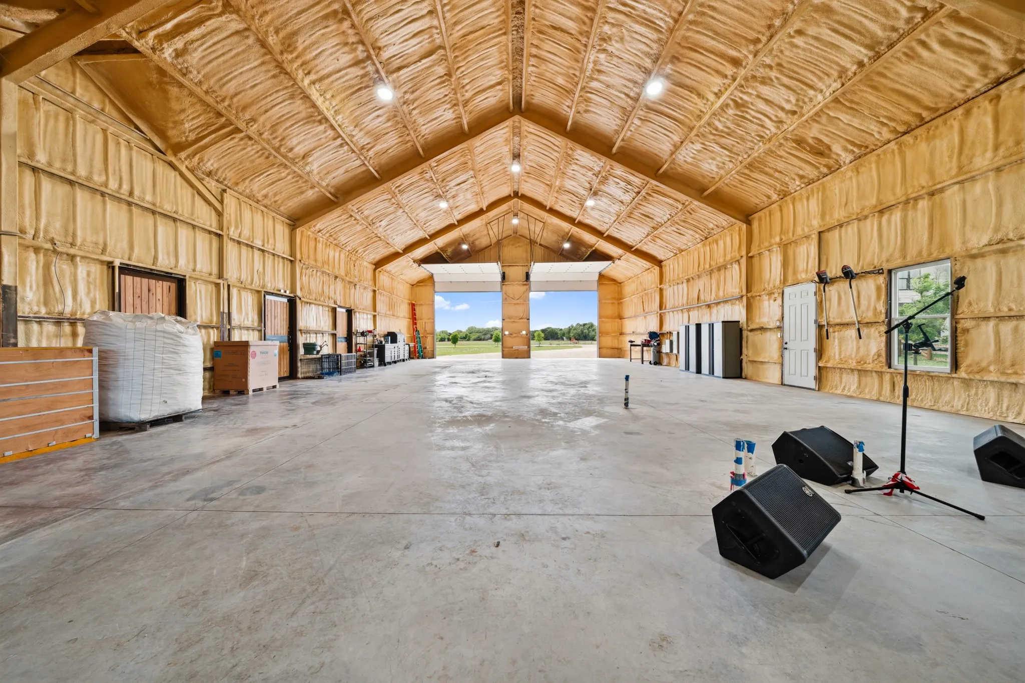 The property features a spacious interior with a high, vaulted ceiling and exposed wooden beams