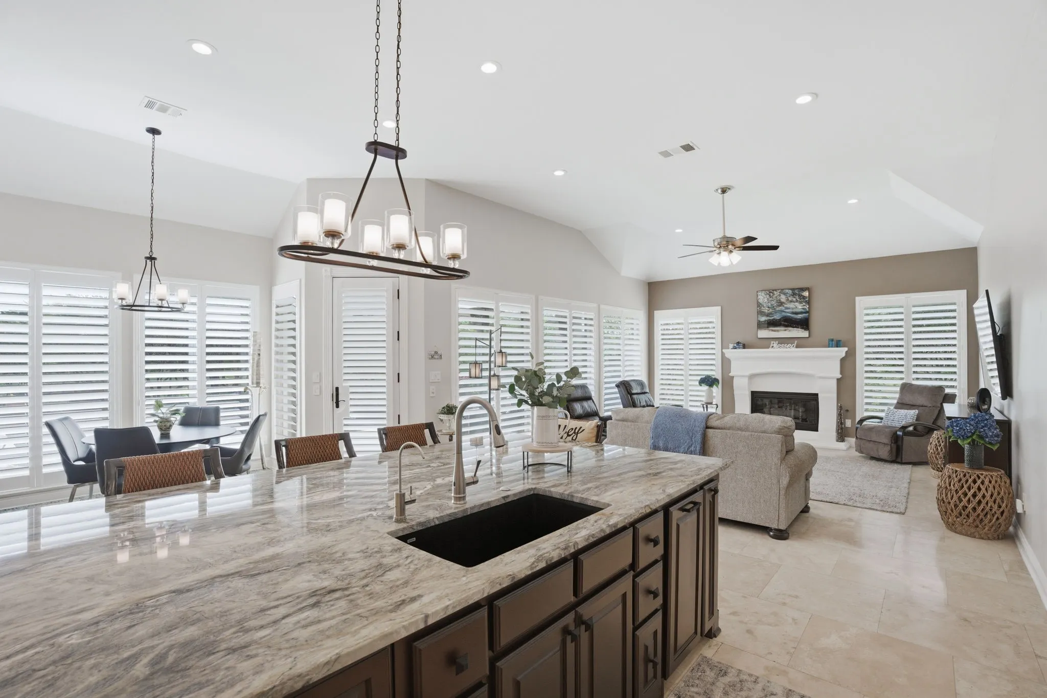 Designer island & breakfast nook light fixture is among the many updated fixtures in the home. New plantation shutters with hidden title rods grace the picture windows ~ all facing the swimming pool & lushly landscaped yard.