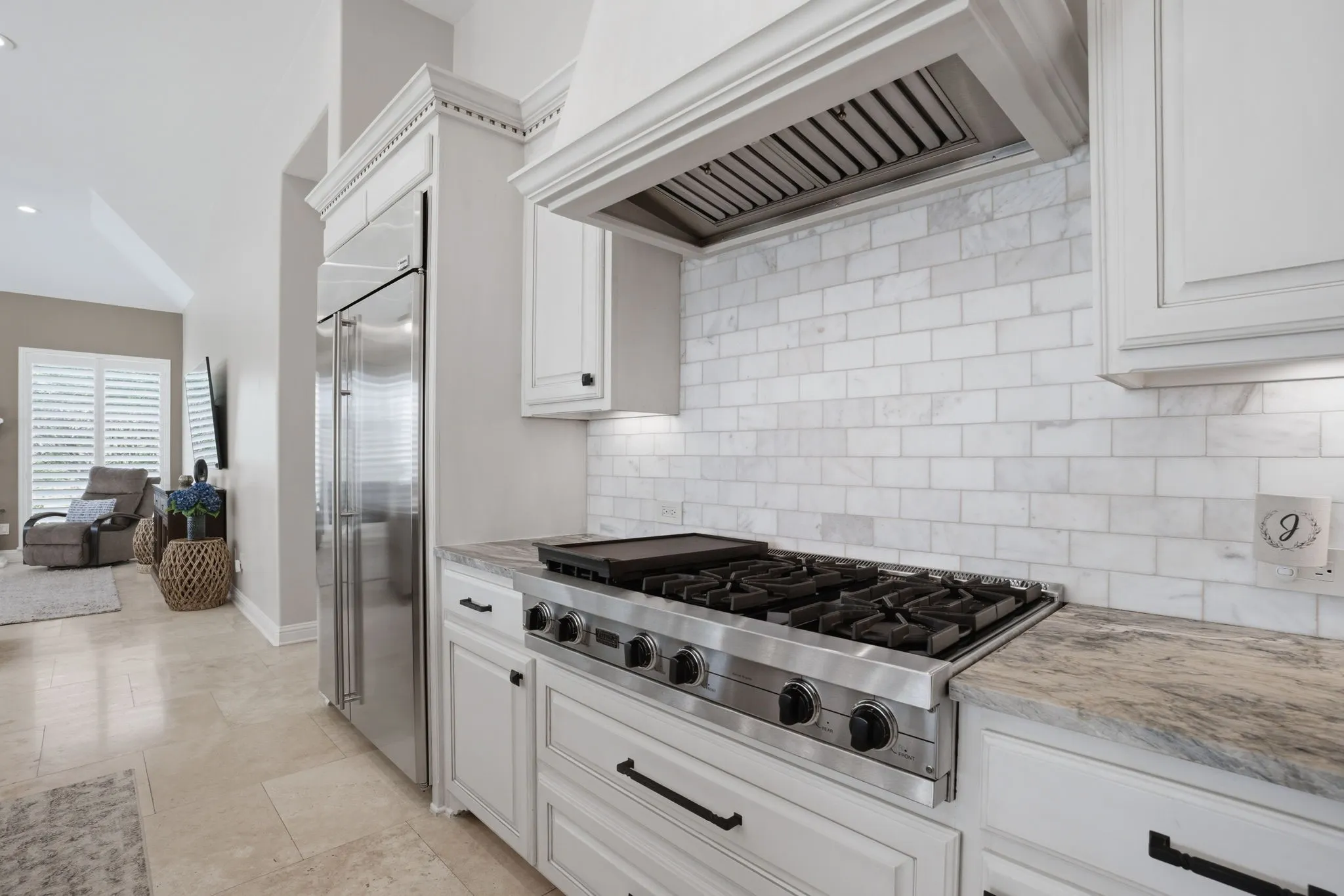 A full compliment of stainless appliances include: a built-in refrigerator, commercial grade 6-burner Viking gas cooktop, double ovens, a microwave.