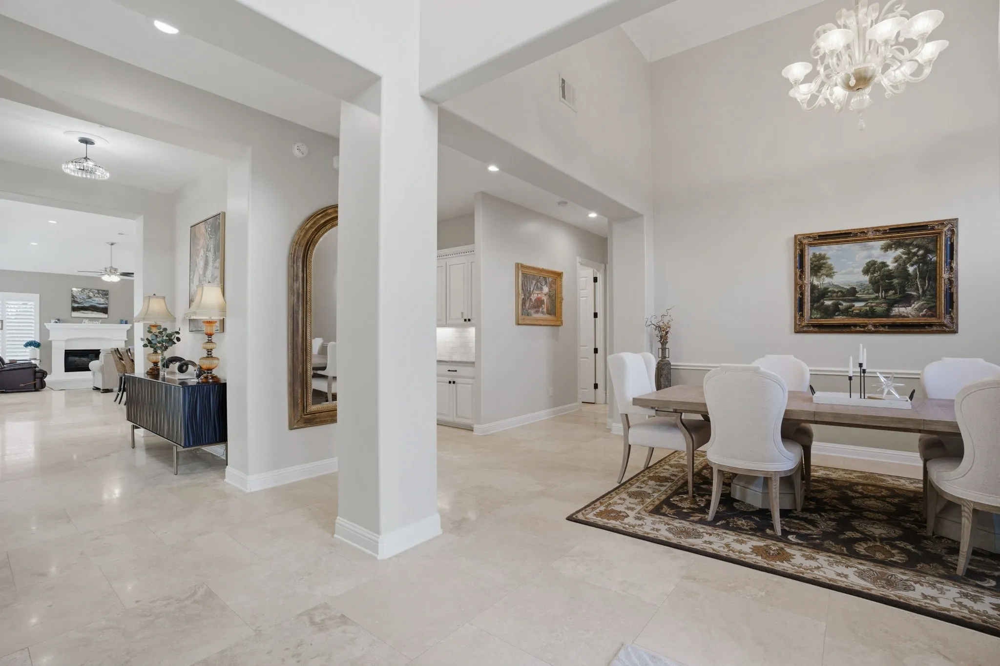 A residence of character & individuality, the architectural dimensions that separate each room also add to seamless flow from front to back. Note the stunning multi-tiered Murano glass chandelier, with a complimentary one in the foyer.