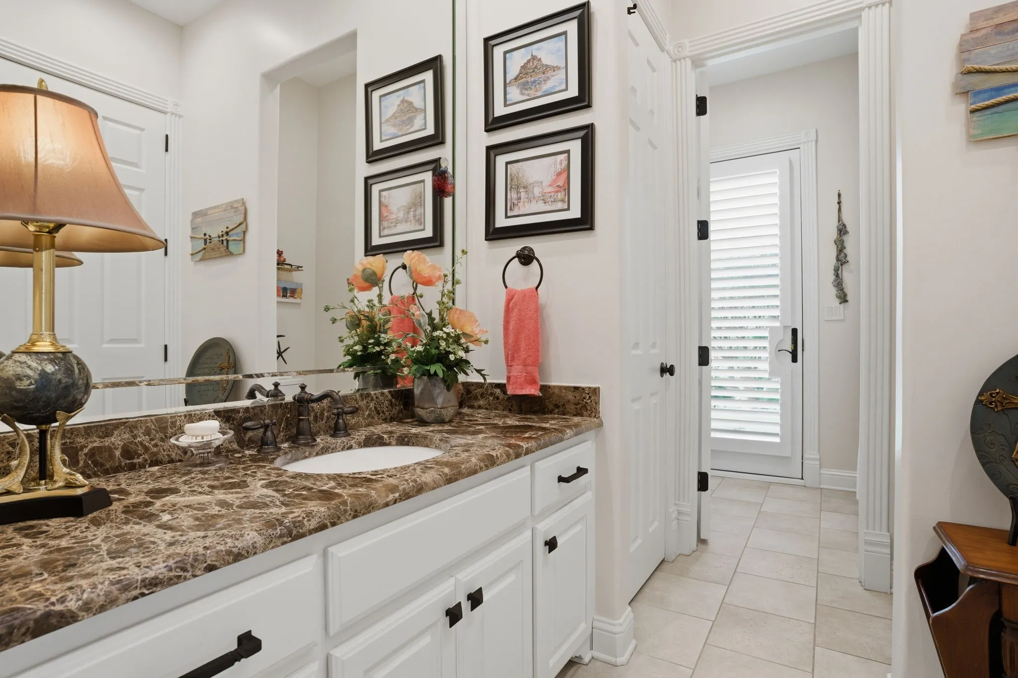 Traditional & sparkling clean full bath also has door access to the backyard & convenient to the swimming pool.