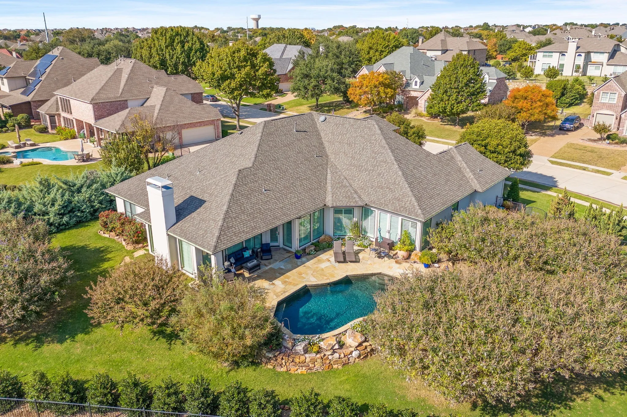 A resort-style swimming pool anchors the backyard, complemented by generous patio space & lush greenery that enhances the home's secluded feel. Properties of this size & caliber in such a great Prosper location are increasingly uncommon, making this an opportunity that truly stands out.