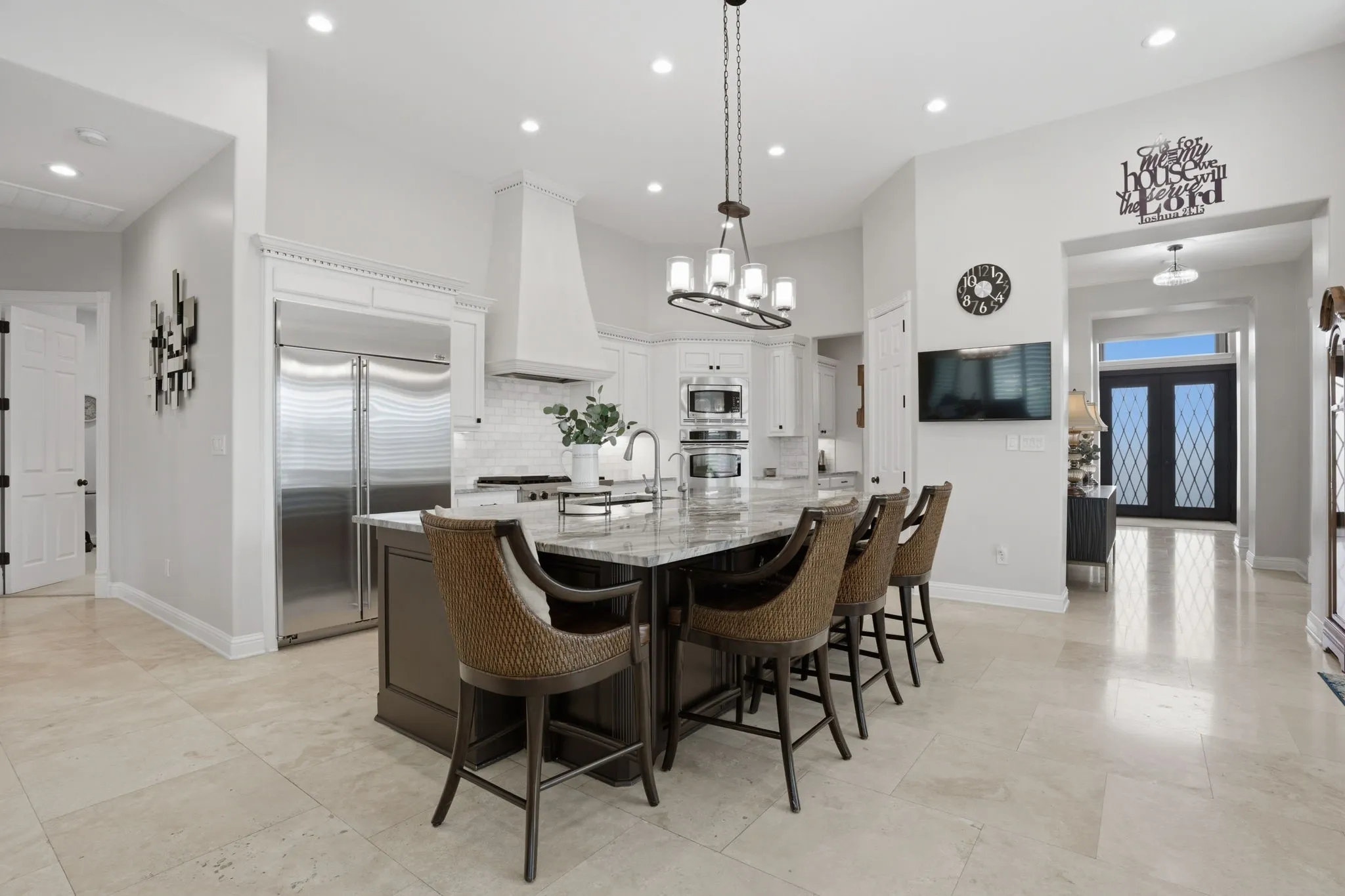 A beautifully reimagined luxury kitchen boasts many upgrades. Among them:  high-end Fusion Quartzite countertops + on the massive island. Picture yourself sitting at the island bar while conversing with the family chef!