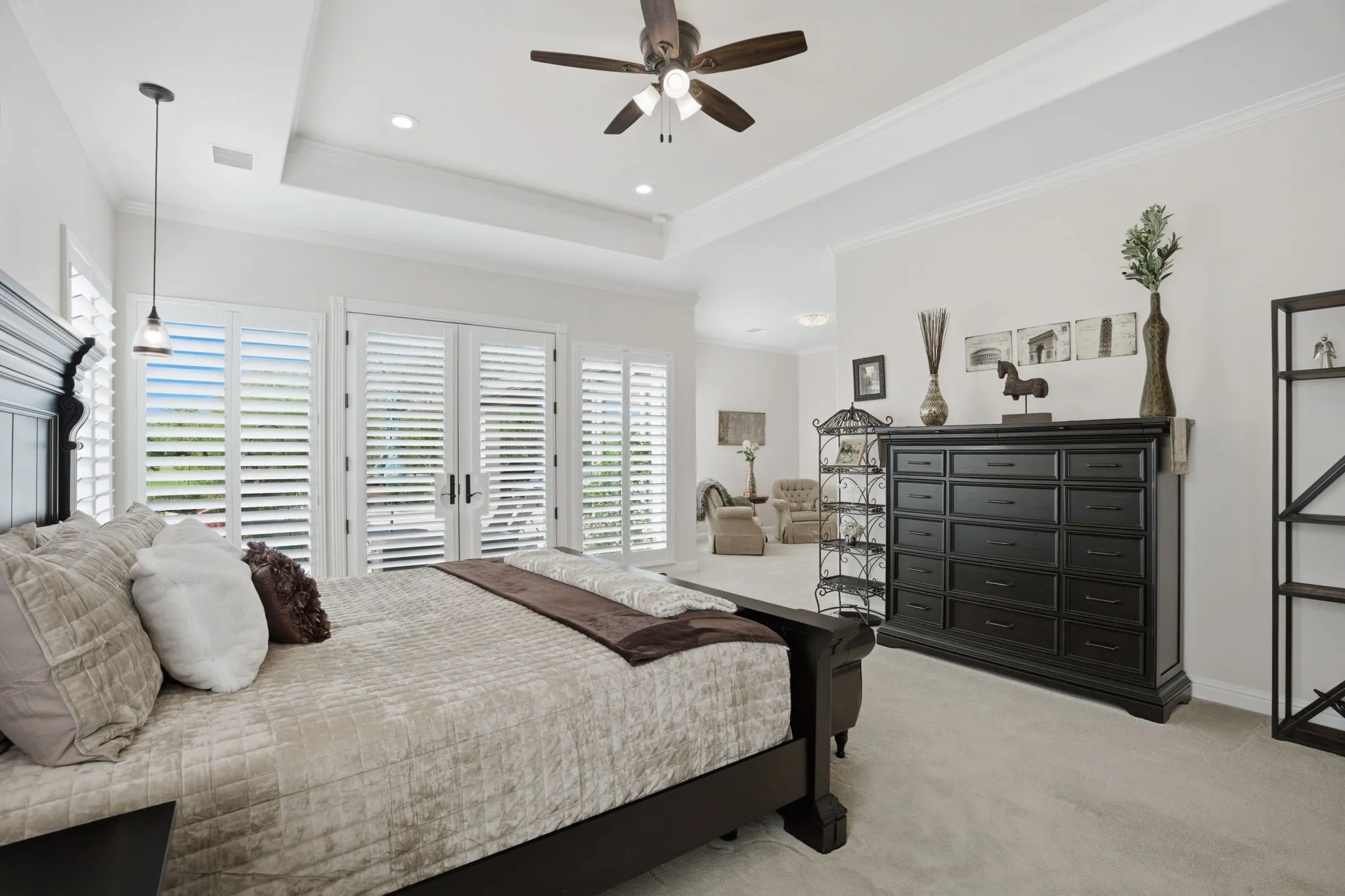 The primary bedroom's spacious dimensions encompass an adjacent sitting area.