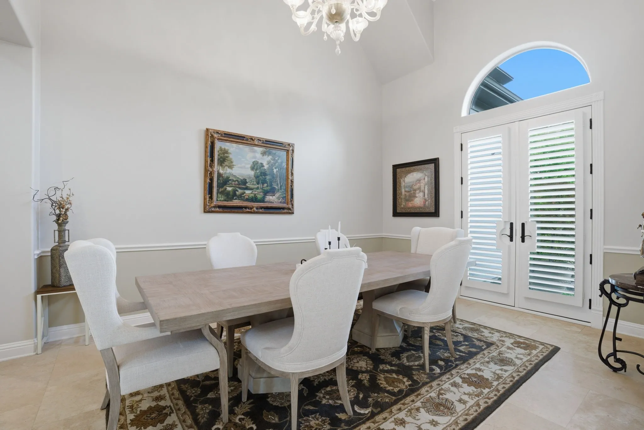 Featuring a formal dining room designed to accommodate any table shape, making it ideal for both intimate dinners or larger gatherings. French doors open directly to the front gardens.
