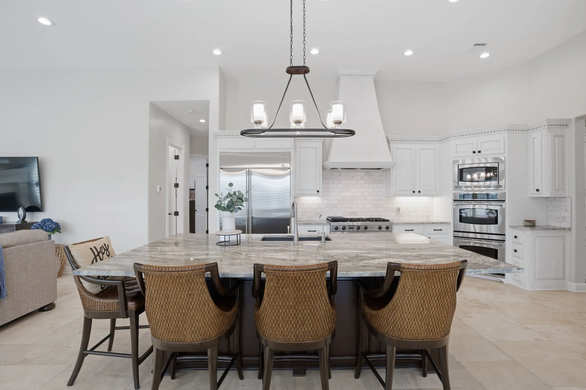 The refreshed kitchen is a true centerpiece of the home, featuring a massive center island that offers ample room for prep, casual dining & gathering of friends. The top-of-the-line Fusion Quartzite countertops are really impressive.