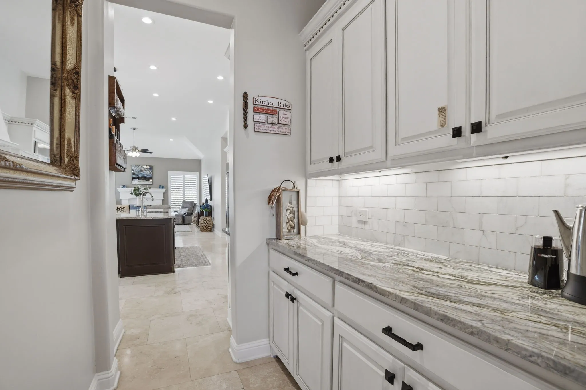 Located between the kitchen & formal dining room is this handy butler pantry. Take note of the subway tile backsplash shown here & in the kitchen.