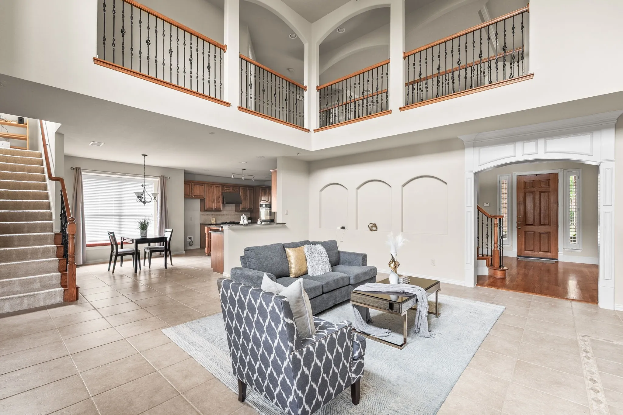 Large family room with soaring ceilings, tons of natural light. Rear staircase for convenience.