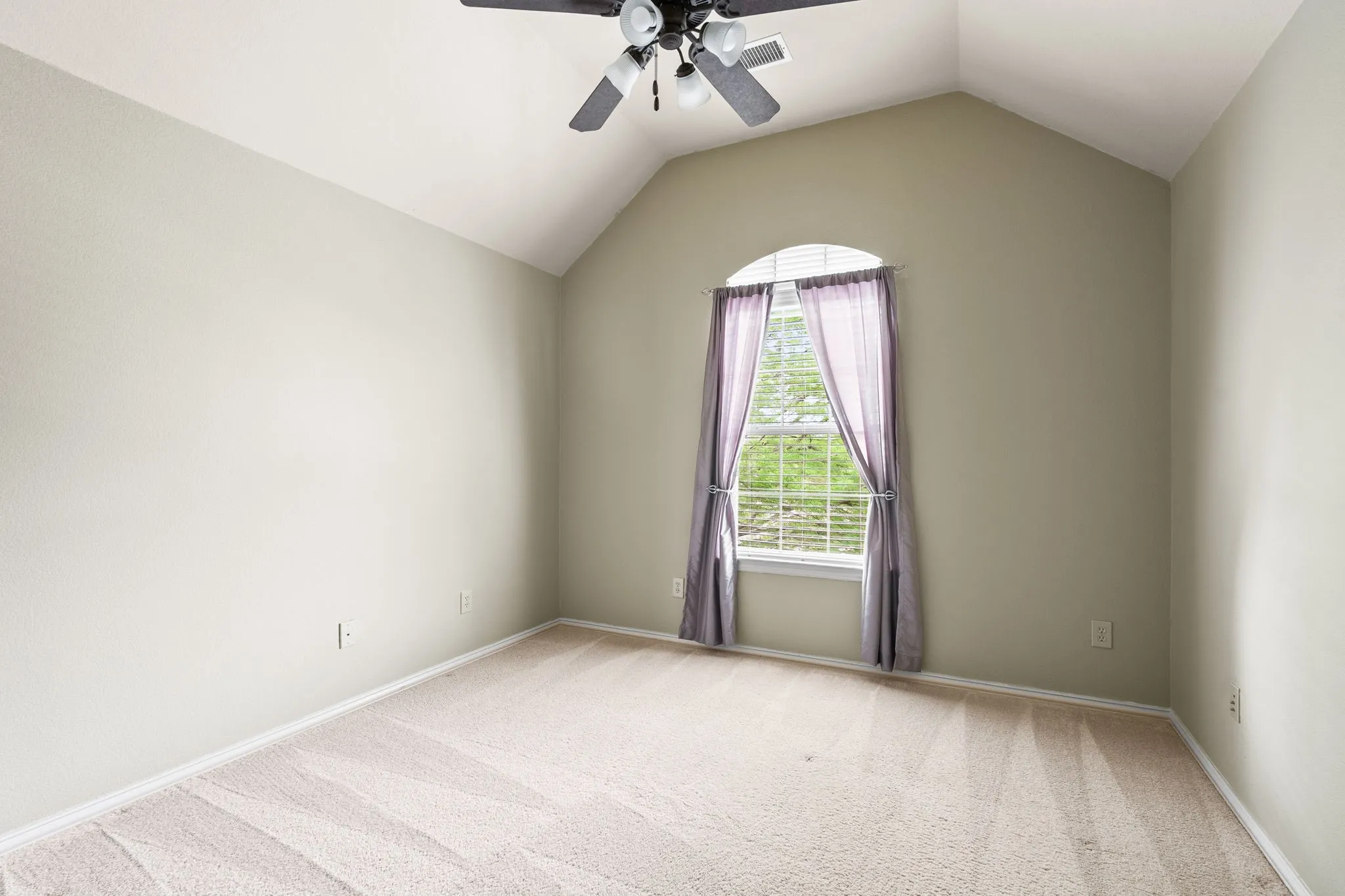 Upstairs bedroom with high ceilings and private bathroom.